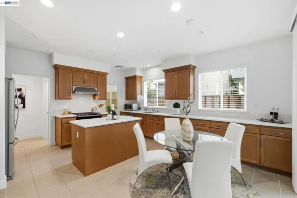 a large kitchen with a table and chairs in it