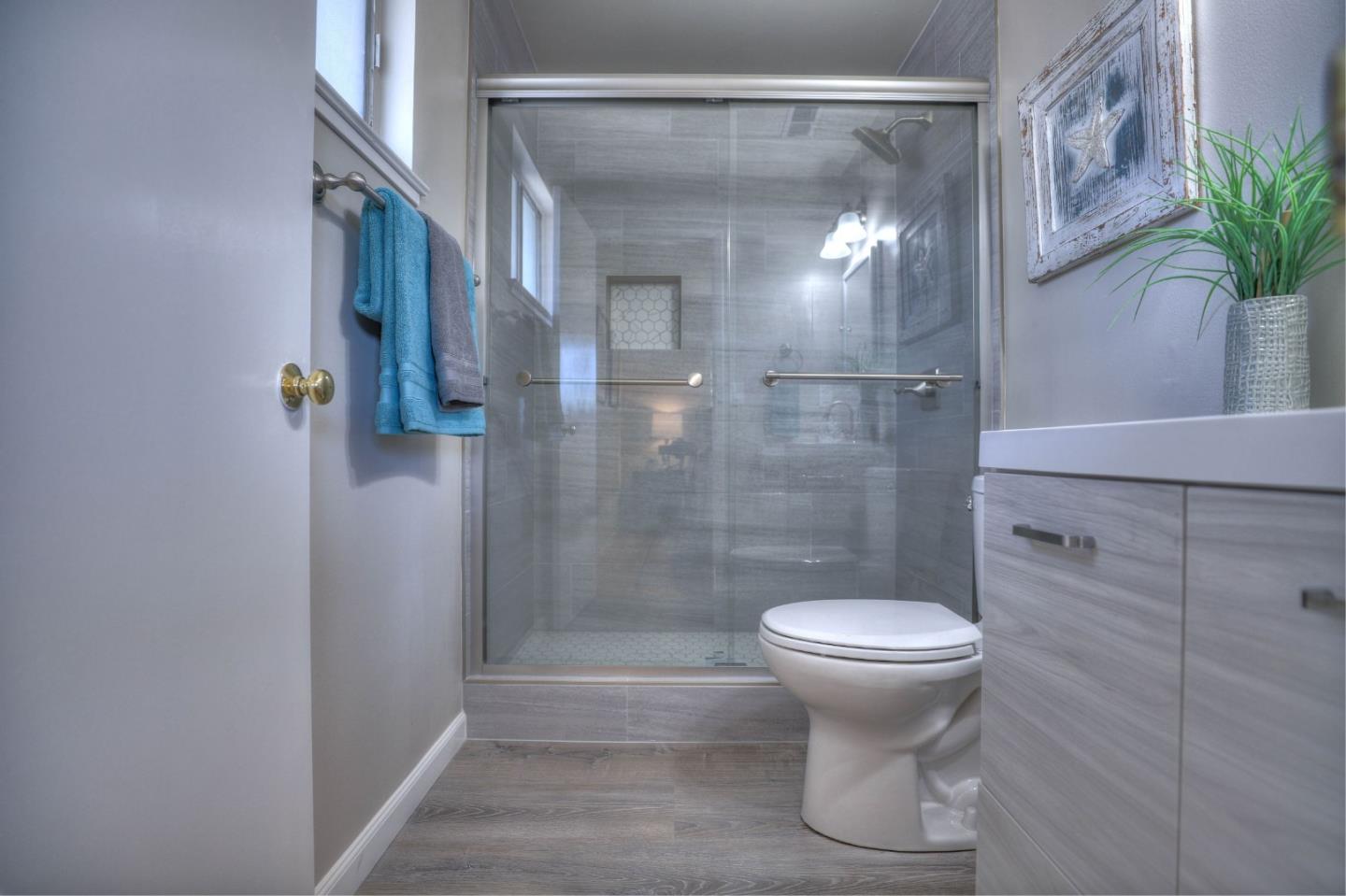3802 West Rincon Avenue Campbell, CA 95008 - Photo 14 of 21 a bathroom with a shower and a toilet