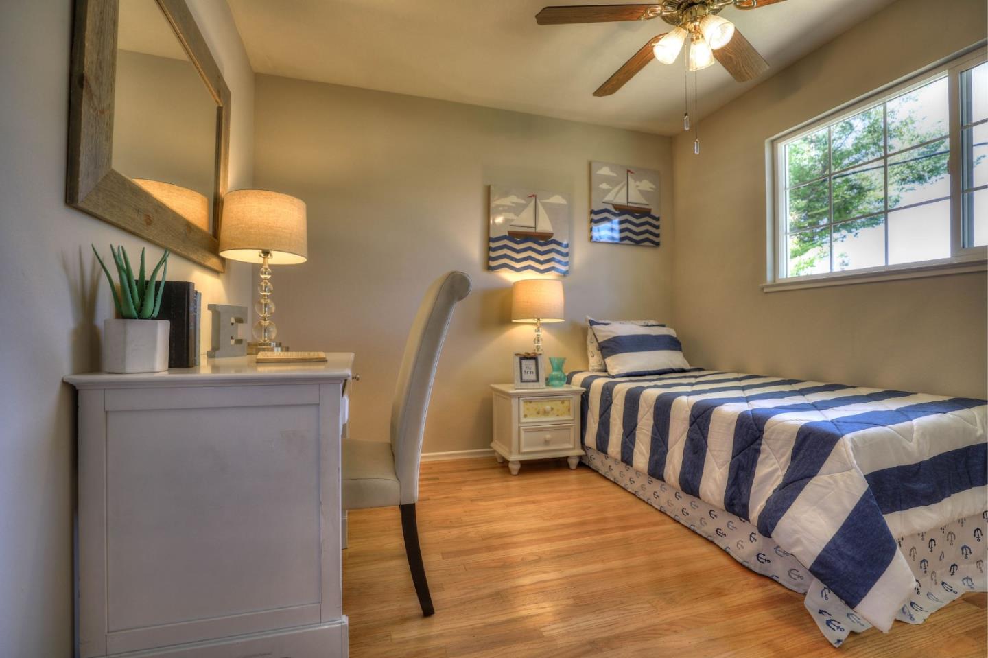 3802 West Rincon Avenue Campbell, CA 95008 - Photo 15 of 21 a bedroom with a bed and a chandelier