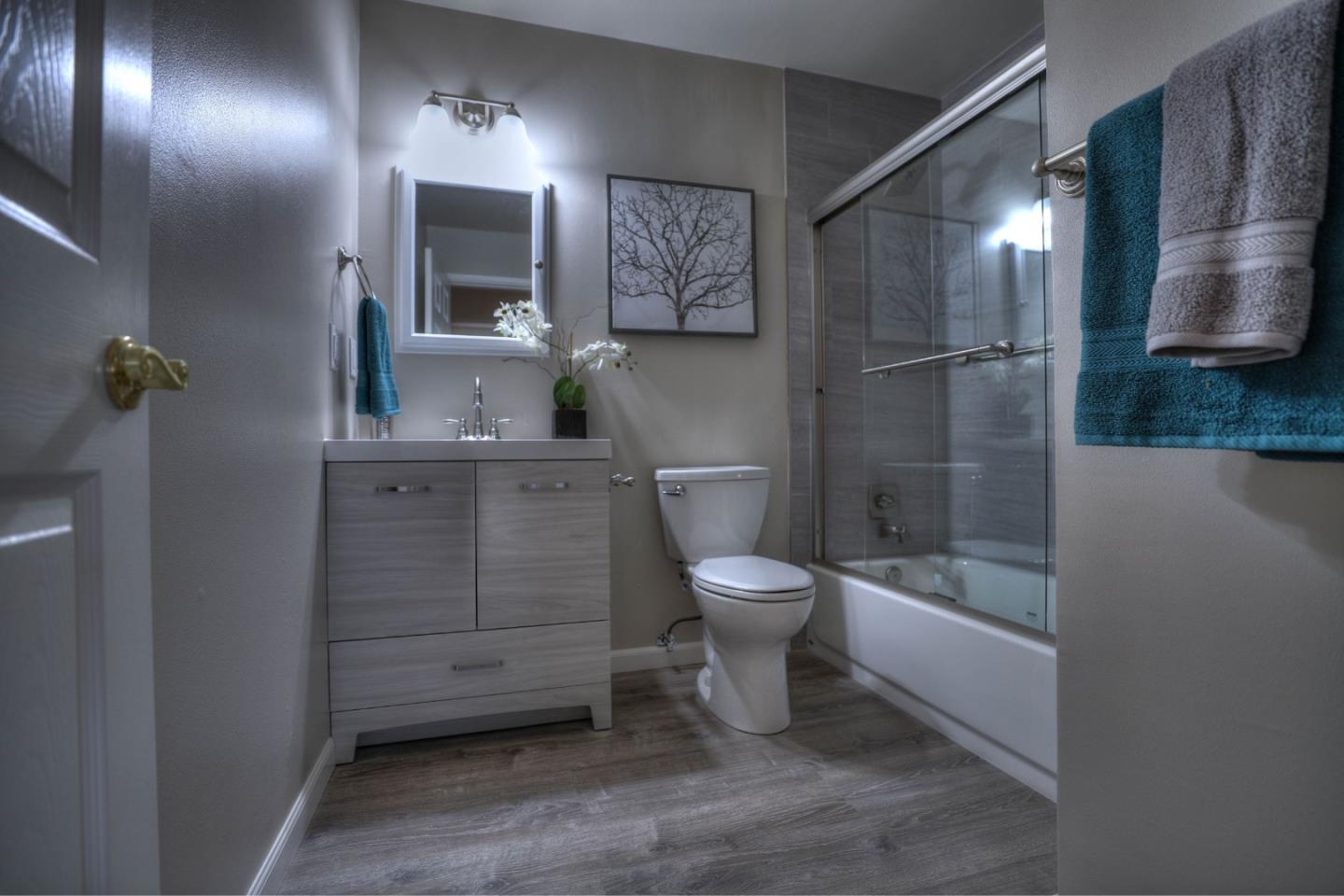 3802 West Rincon Avenue Campbell, CA 95008 - Photo 17 of 21 a bathroom with a toilet a sink and mirror