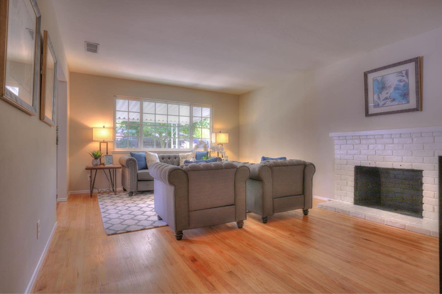 3802 West Rincon Avenue Campbell, CA 95008 - Photo 4 of 21 a living room with furniture and a fireplace