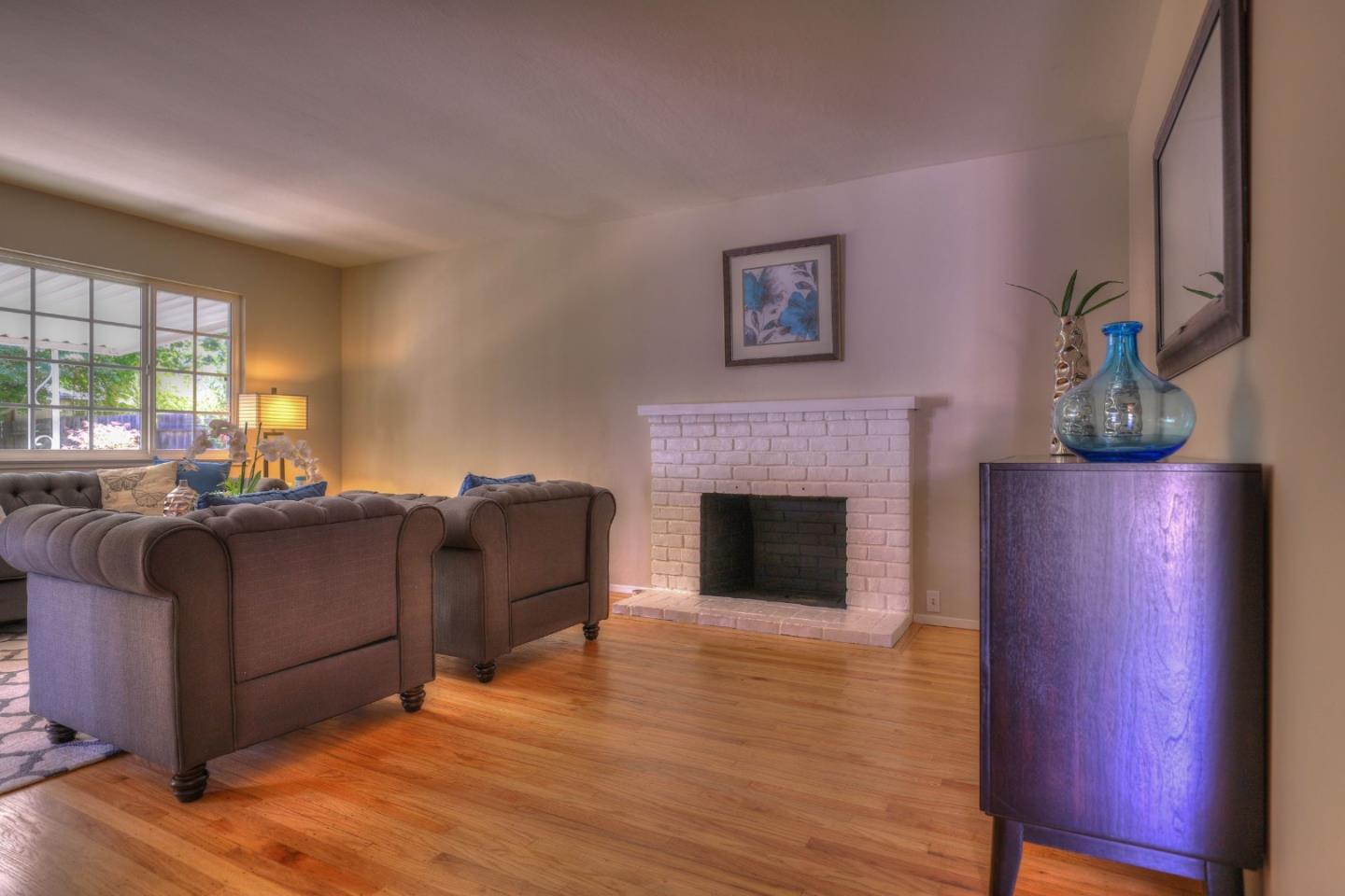 3802 West Rincon Avenue Campbell, CA 95008 - Photo 5 of 21 a living room with furniture and a fireplace