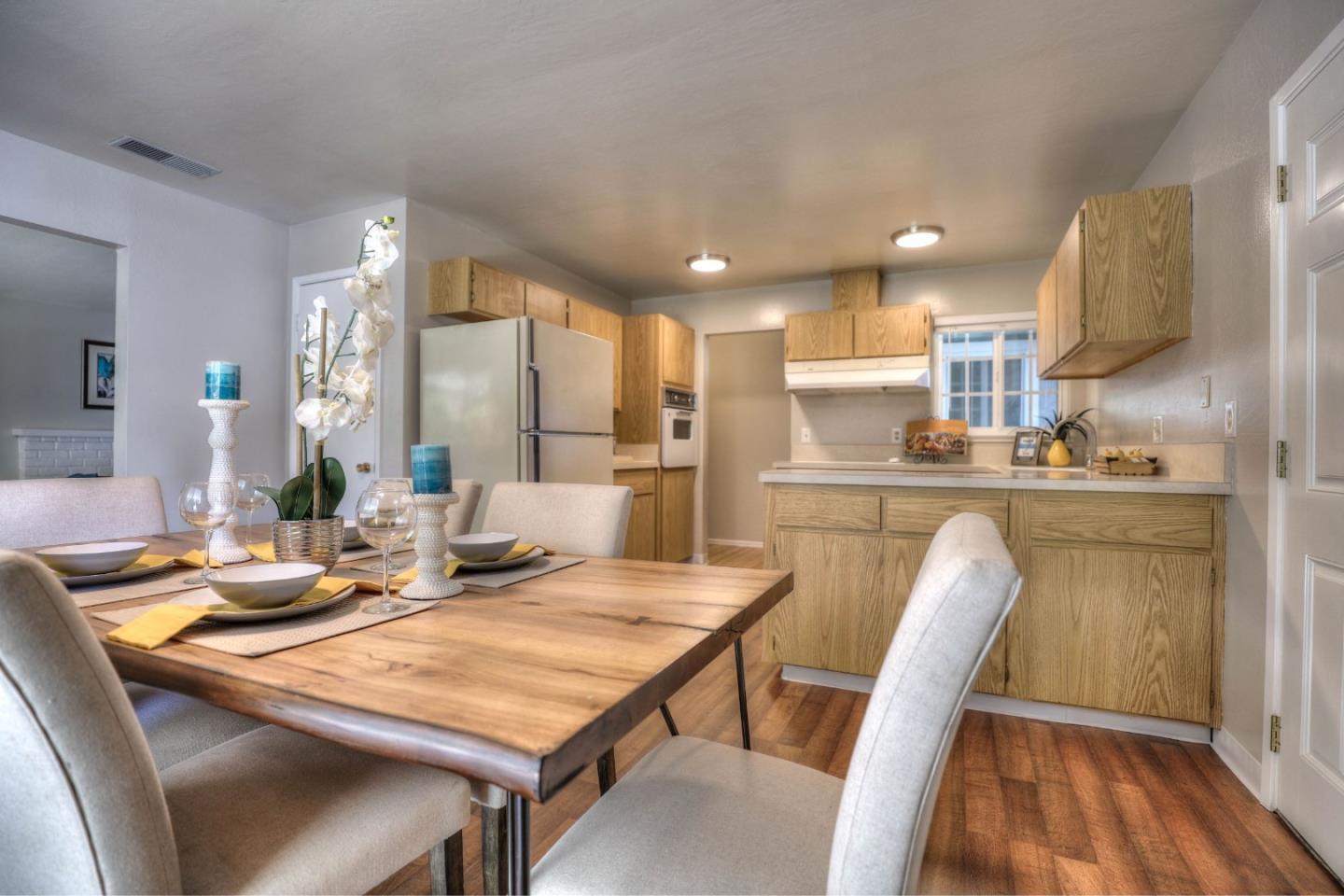 3802 West Rincon Avenue Campbell, CA 95008 - Photo 7 of 21 a kitchen with a table chairs sink and refrigerator