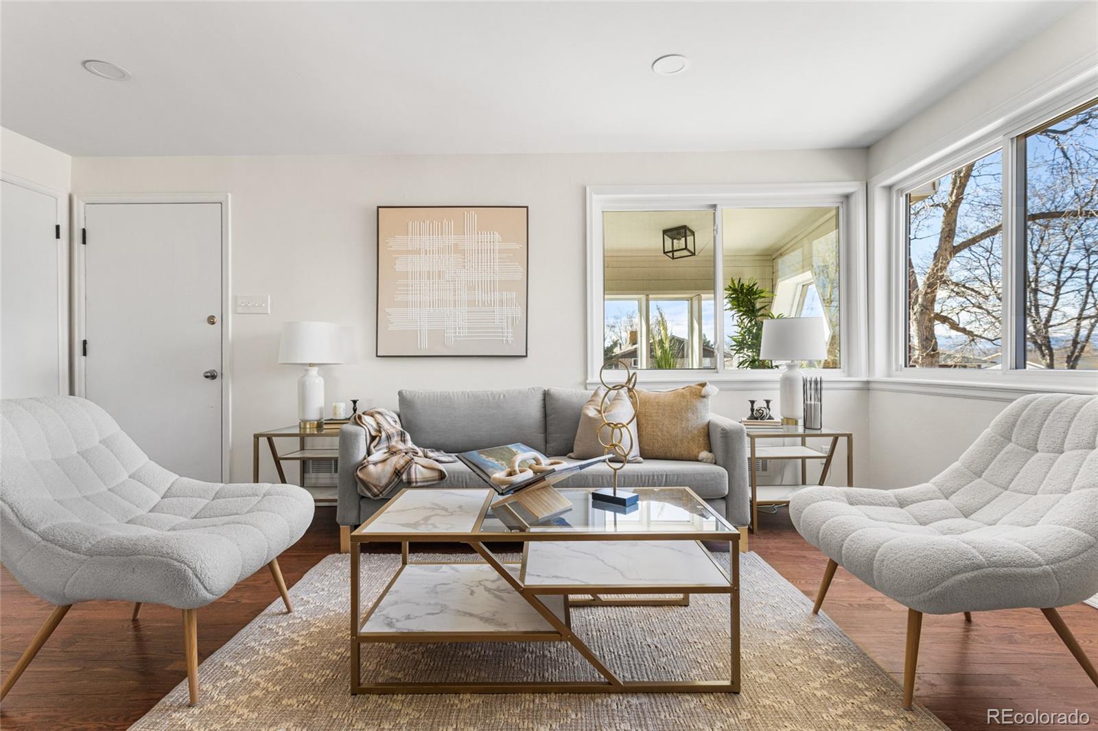 8140 Raleigh Street Westminster, CO 80031 - Photo 12 of 39 a living room with furniture a large window and a table