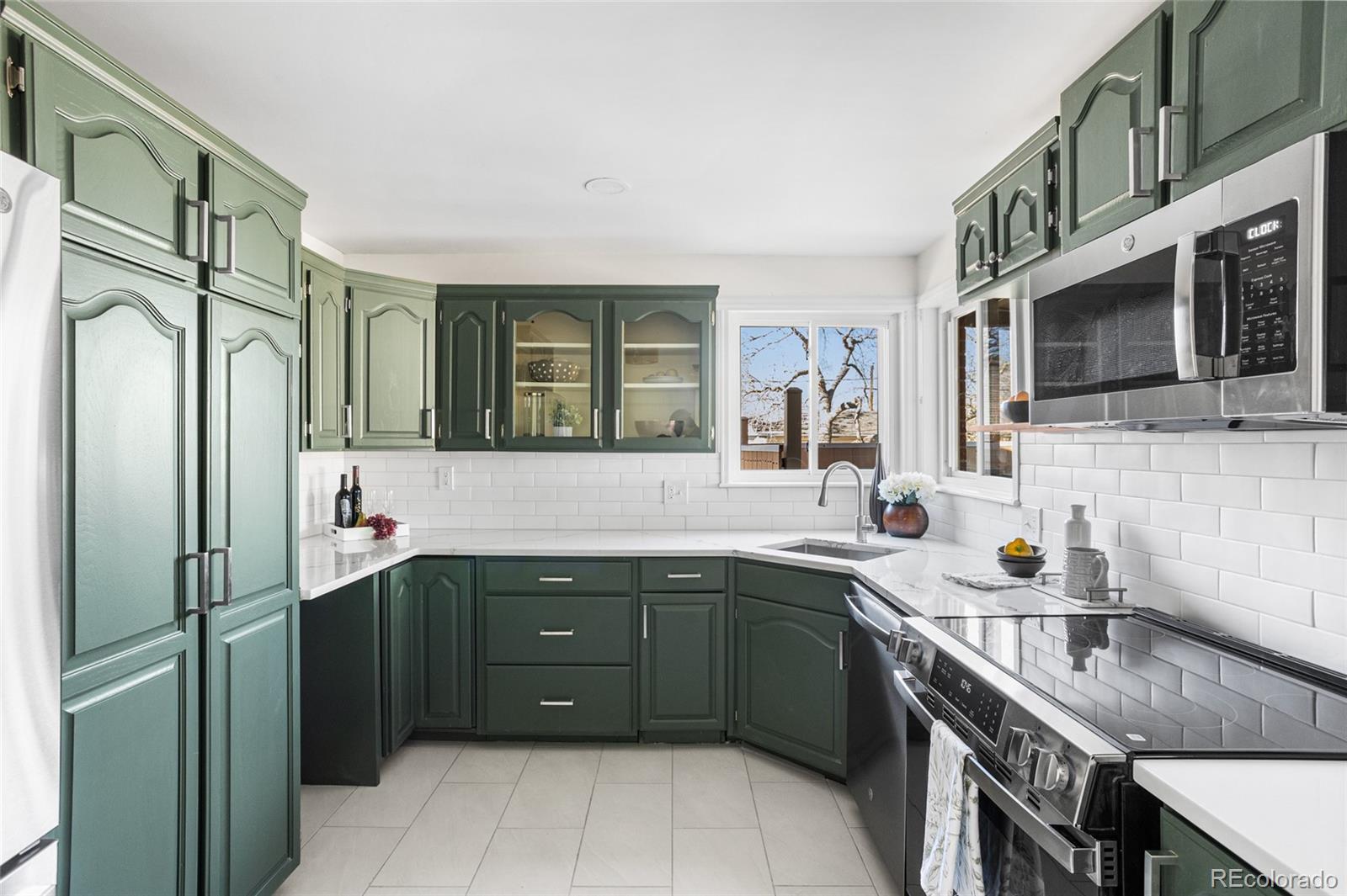 8140 Raleigh Street Westminster, CO 80031 - Photo 16 of 39 a kitchen with stainless steel appliances a sink stove and refrigerator