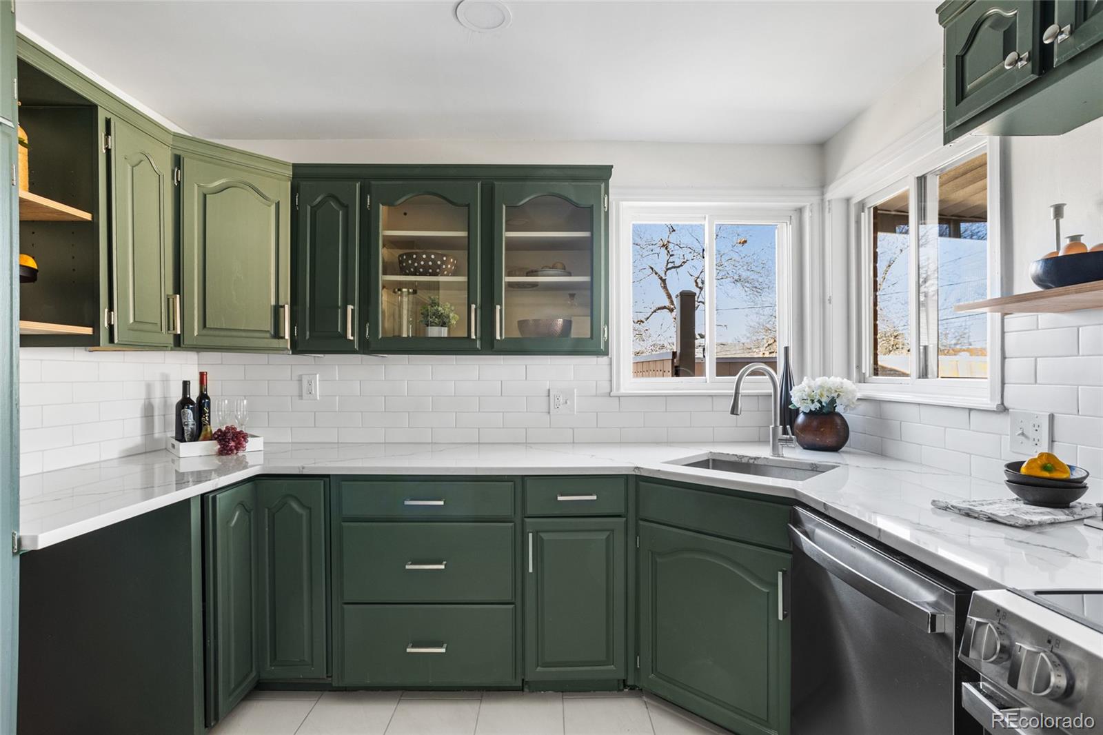 8140 Raleigh Street Westminster, CO 80031 - Photo 18 of 39 a kitchen with a sink and cabinets