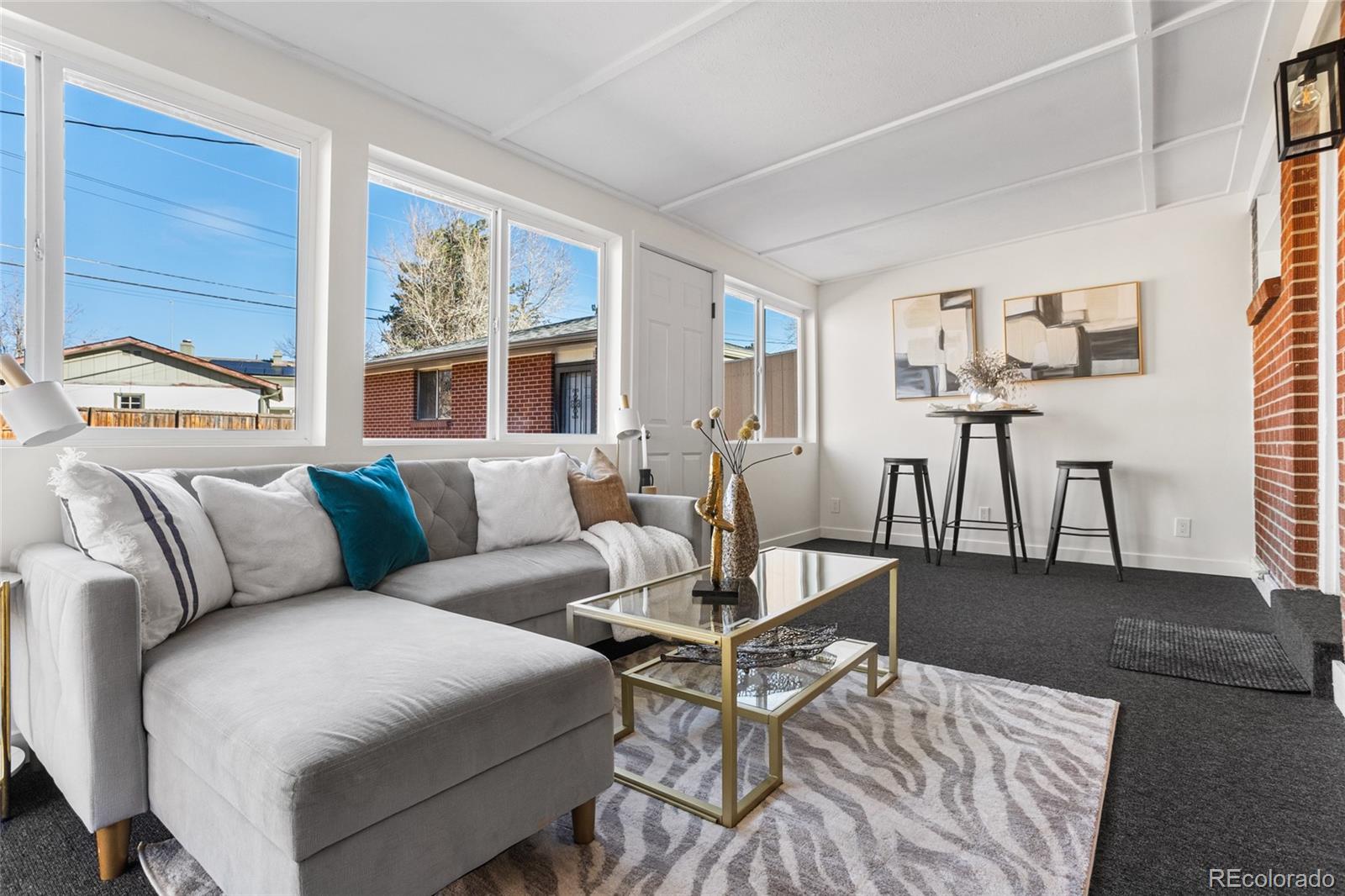 8140 Raleigh Street Westminster, CO 80031 - Photo 21 of 39 a living room with furniture and a table