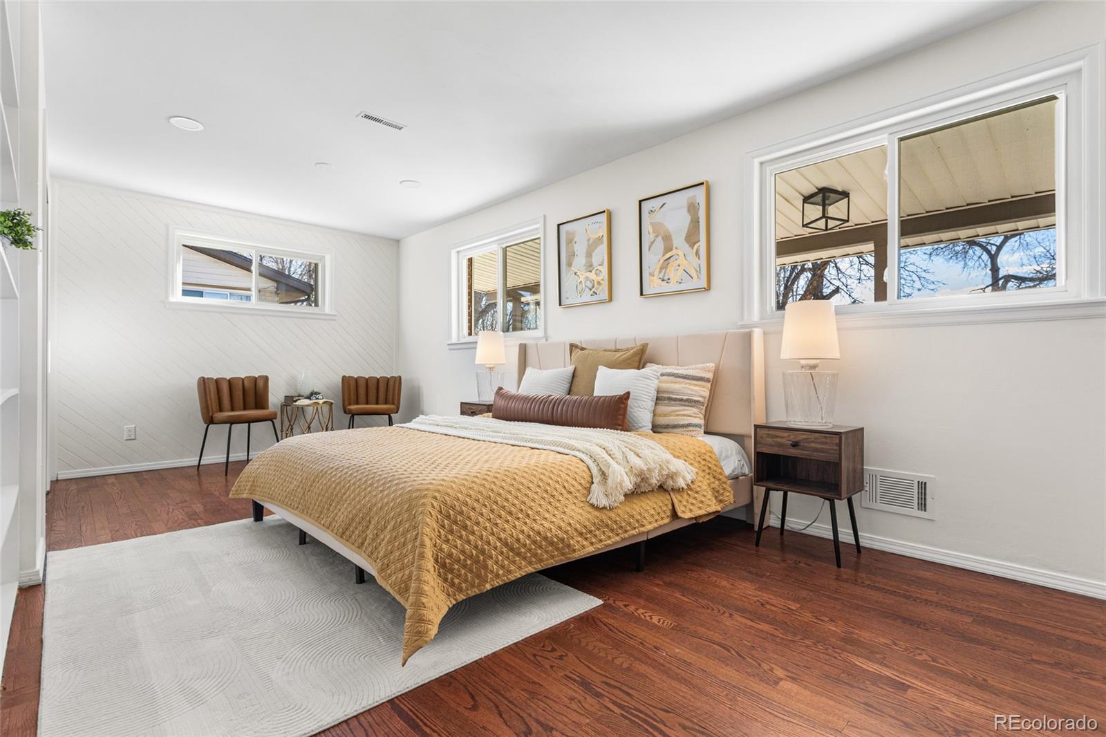 8140 Raleigh Street Westminster, CO 80031 - Photo 22 of 39 a bedroom with a bed and a chair