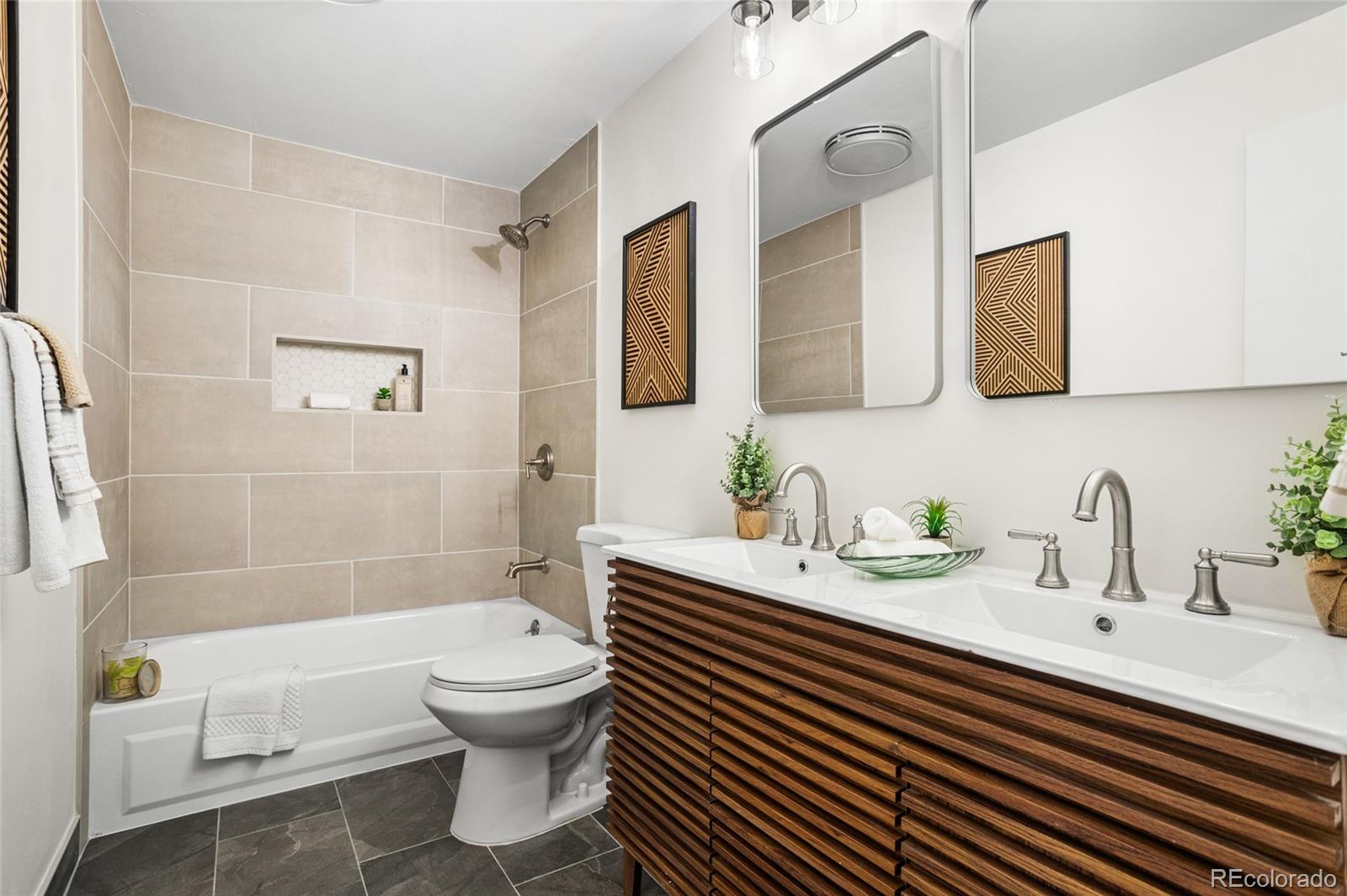 8140 Raleigh Street Westminster, CO 80031 - Photo 25 of 39 a bathroom with a sink a toilet and shower