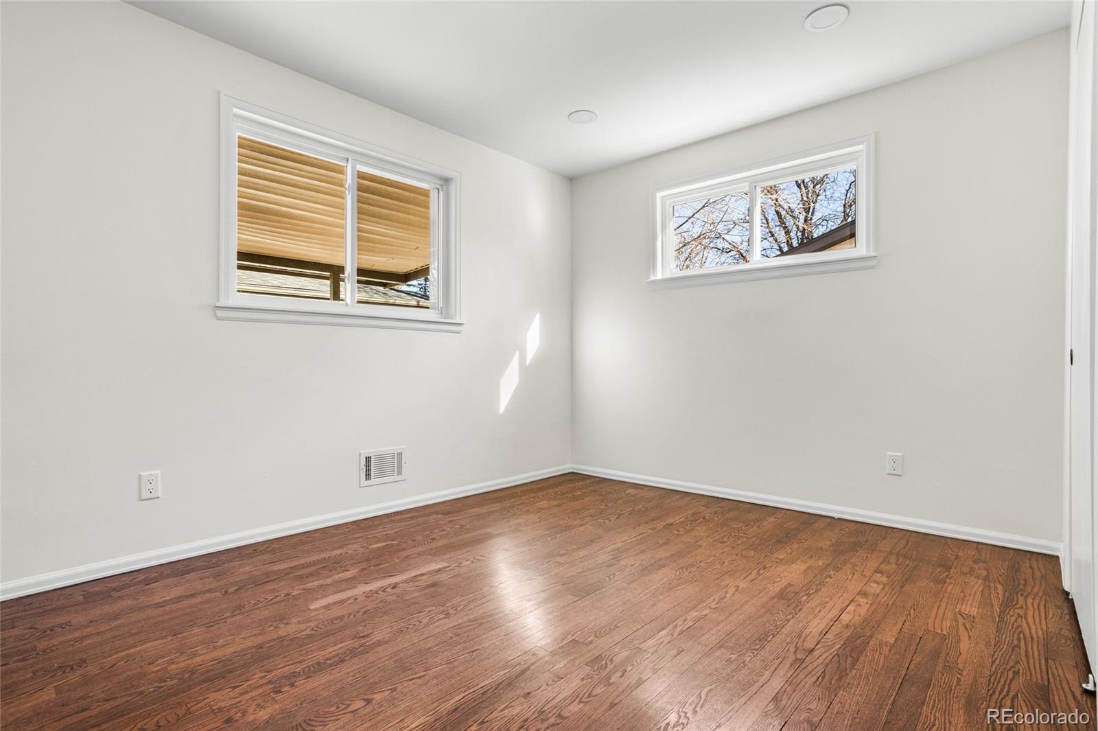 8140 Raleigh Street Westminster, CO 80031 - Photo 26 of 39 a view of empty room with wooden floor and window
