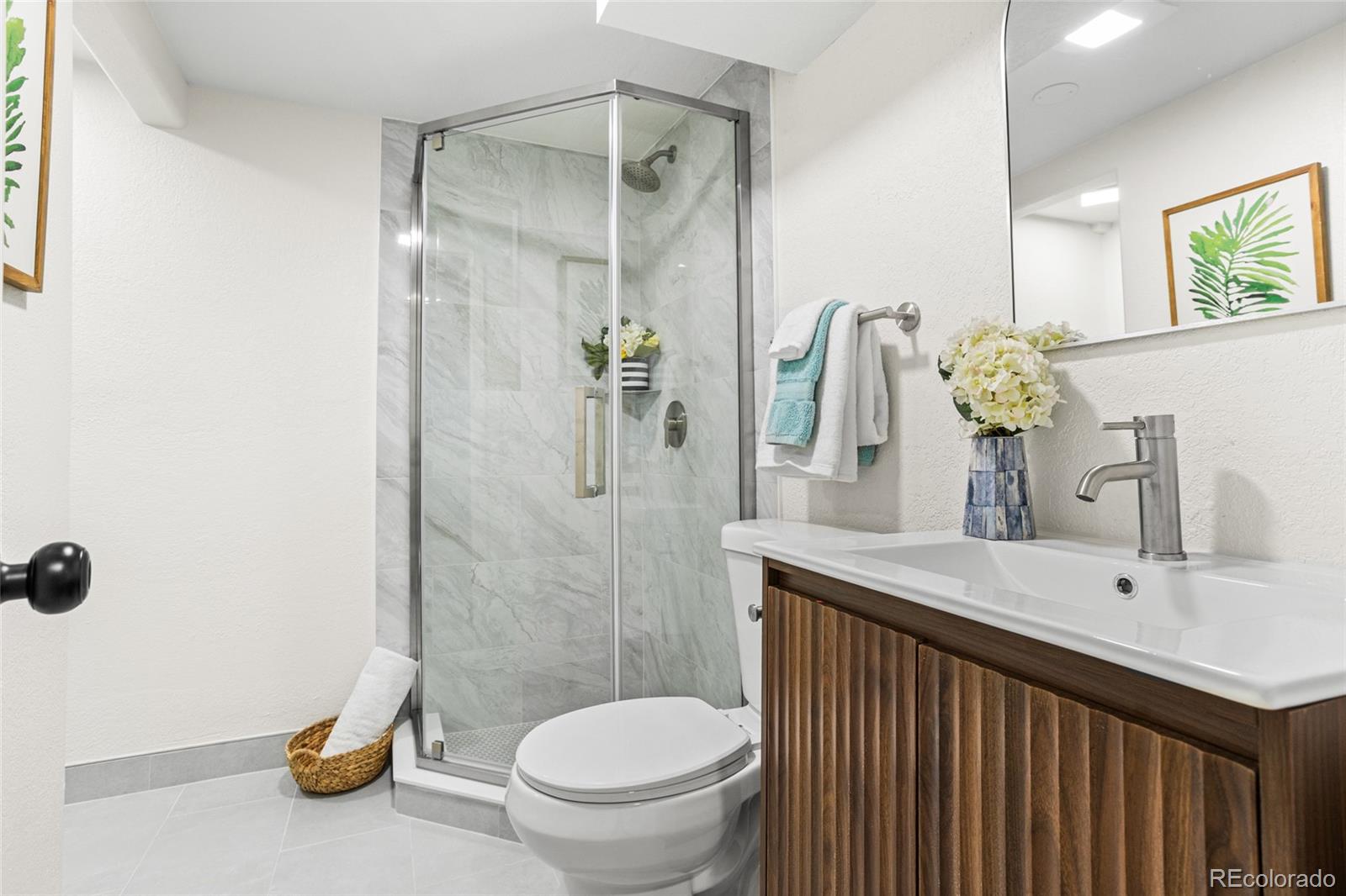 8140 Raleigh Street Westminster, CO 80031 - Photo 31 of 39 a bathroom with a sink a toilet and shower