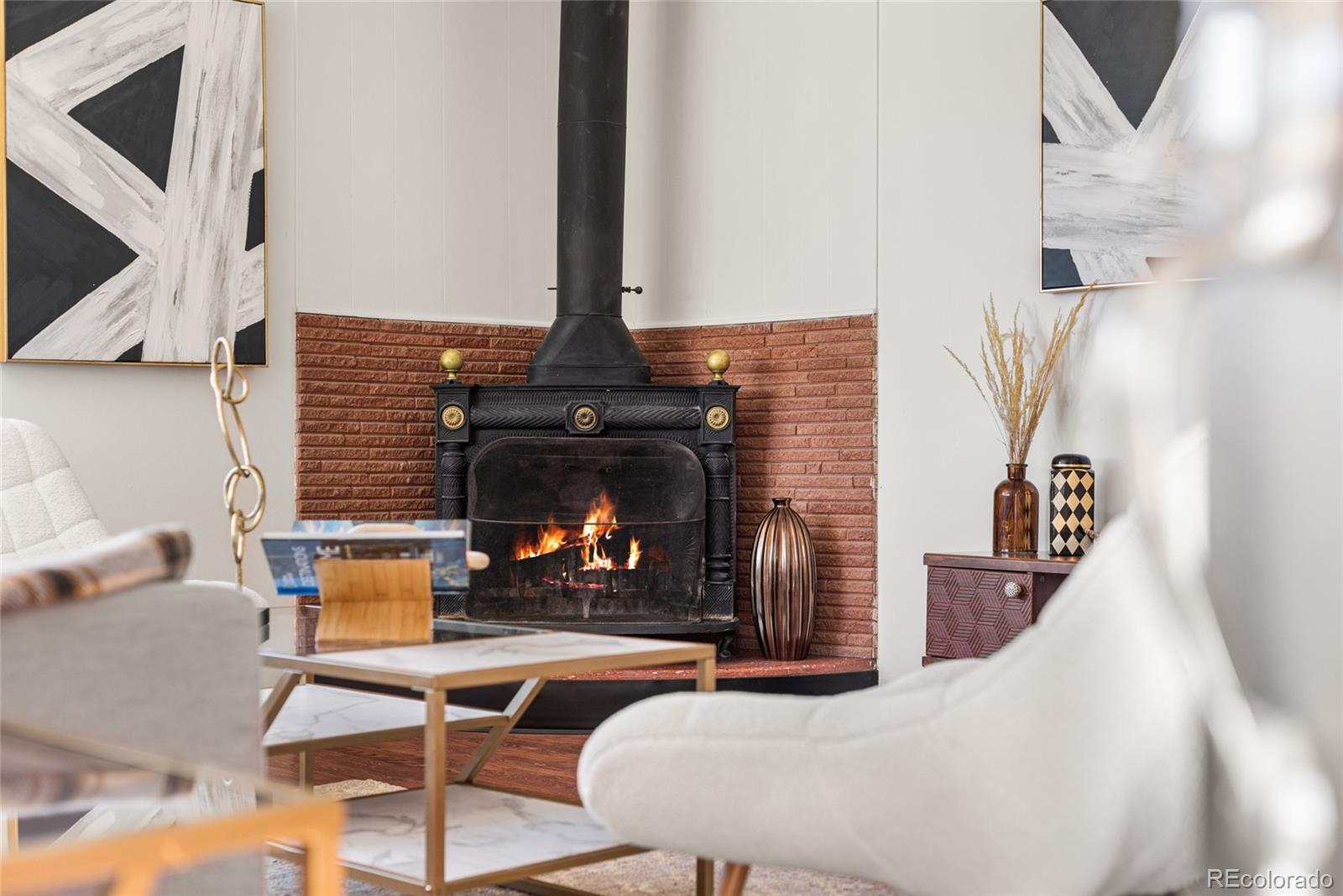 8140 Raleigh Street Westminster, CO 80031 - Photo 9 of 39 a living room with furniture and a fireplace