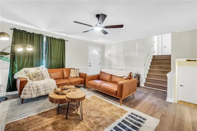 a living room with furniture and wooden floor