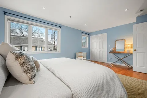 a bedroom with a bed and a large window