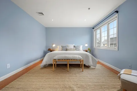 a bed room with a bed and a chair