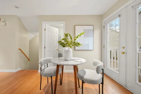 a dining room with furniture and wooden floor