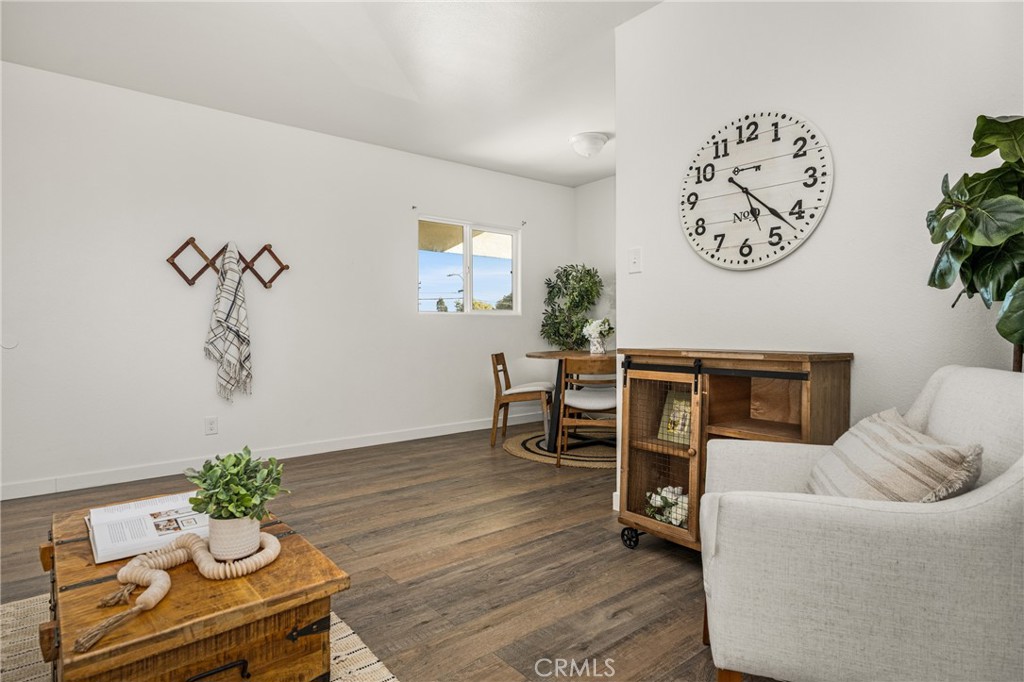 6725 Perry Road Bell Gardens, CA 90201 - Photo 17 of 40 a living room with furniture a clock and a window