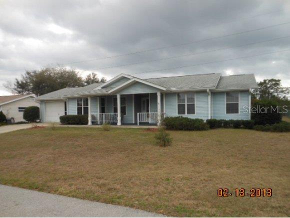 8910 Southwest 116th Place Road Ocala, FL 34481 - Photo 1 of 1 a front view of a house with a garden
