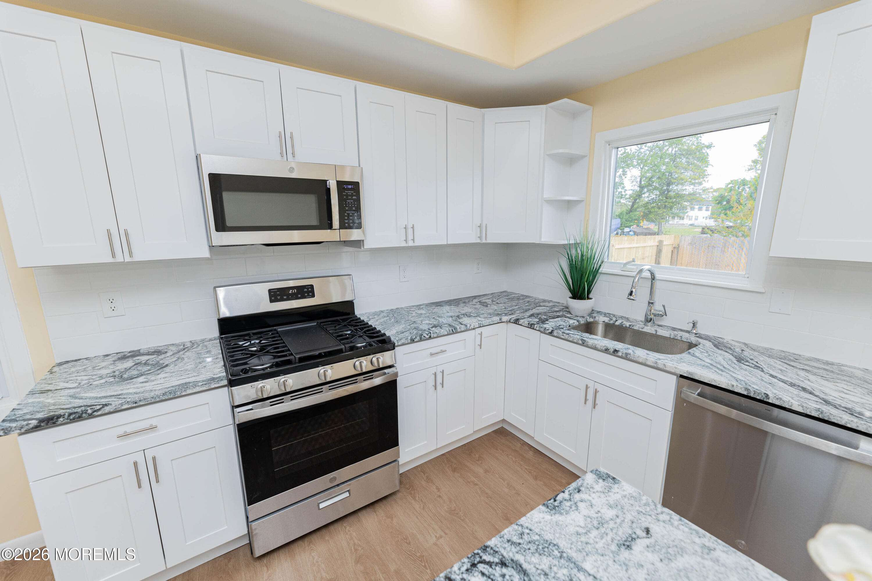 2408 Herbertsville Road Point Pleasant, NJ 08742 - Photo 6 of 82 a kitchen with granite countertop white cabinets appliances a window and a sink