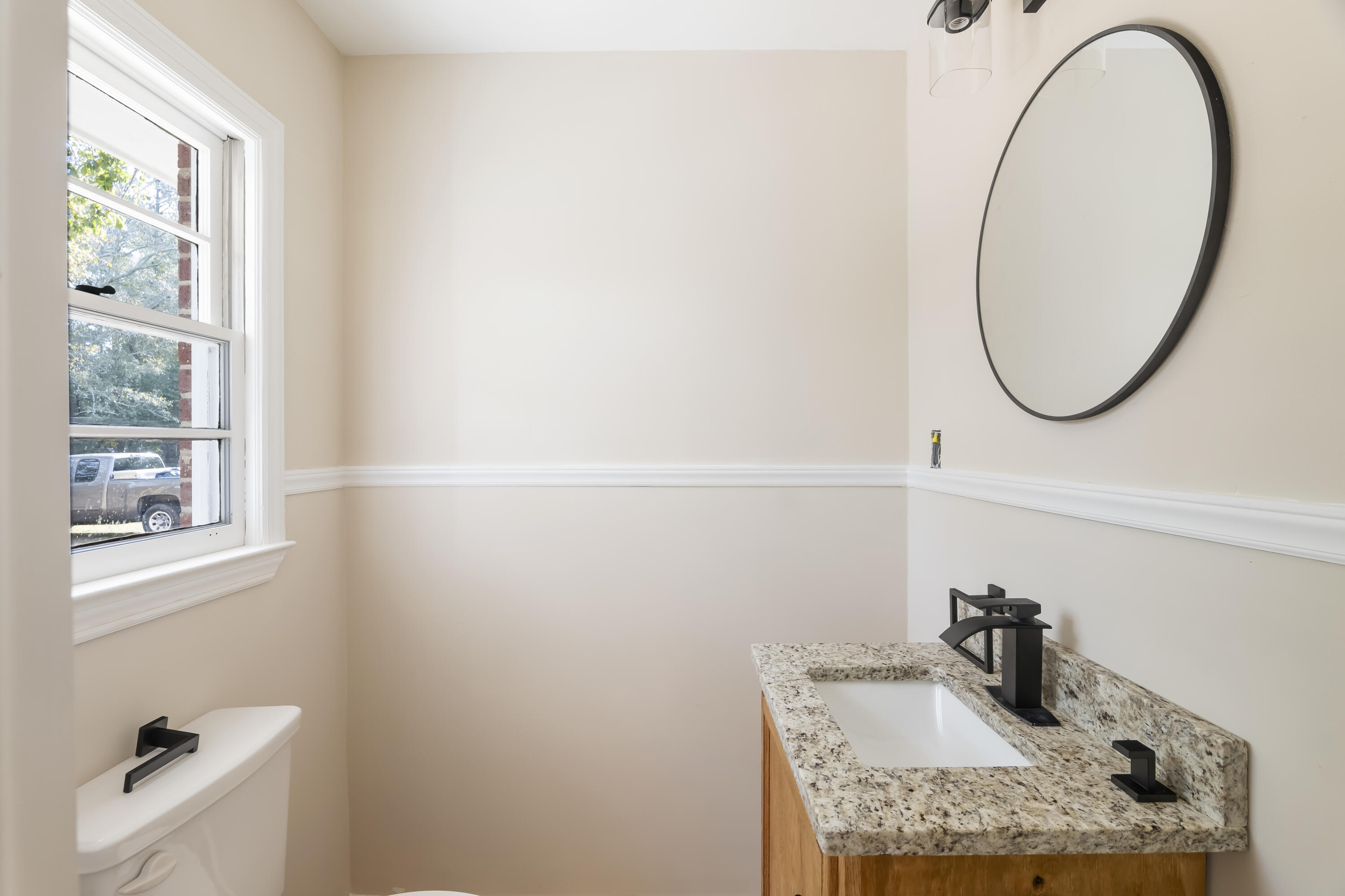 39 Gantt Street Wagener, SC 29164 - Photo 13 of 30 a bathroom with a granite countertop sink and a mirror