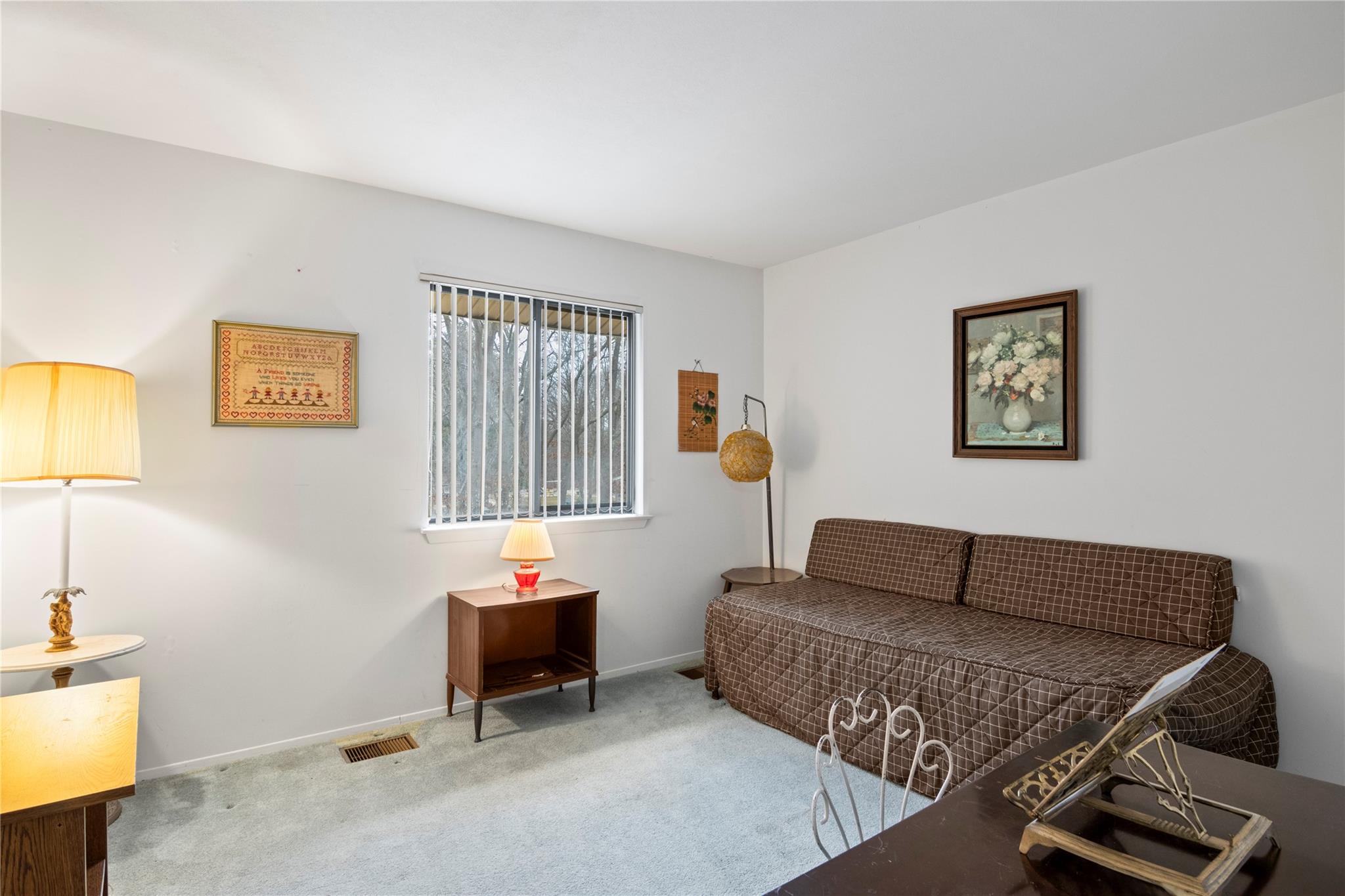 154 Birchwood Road Coram, NY 11727 - Photo 11 of 13 Living area with visible vents, carpet floors, and baseboards