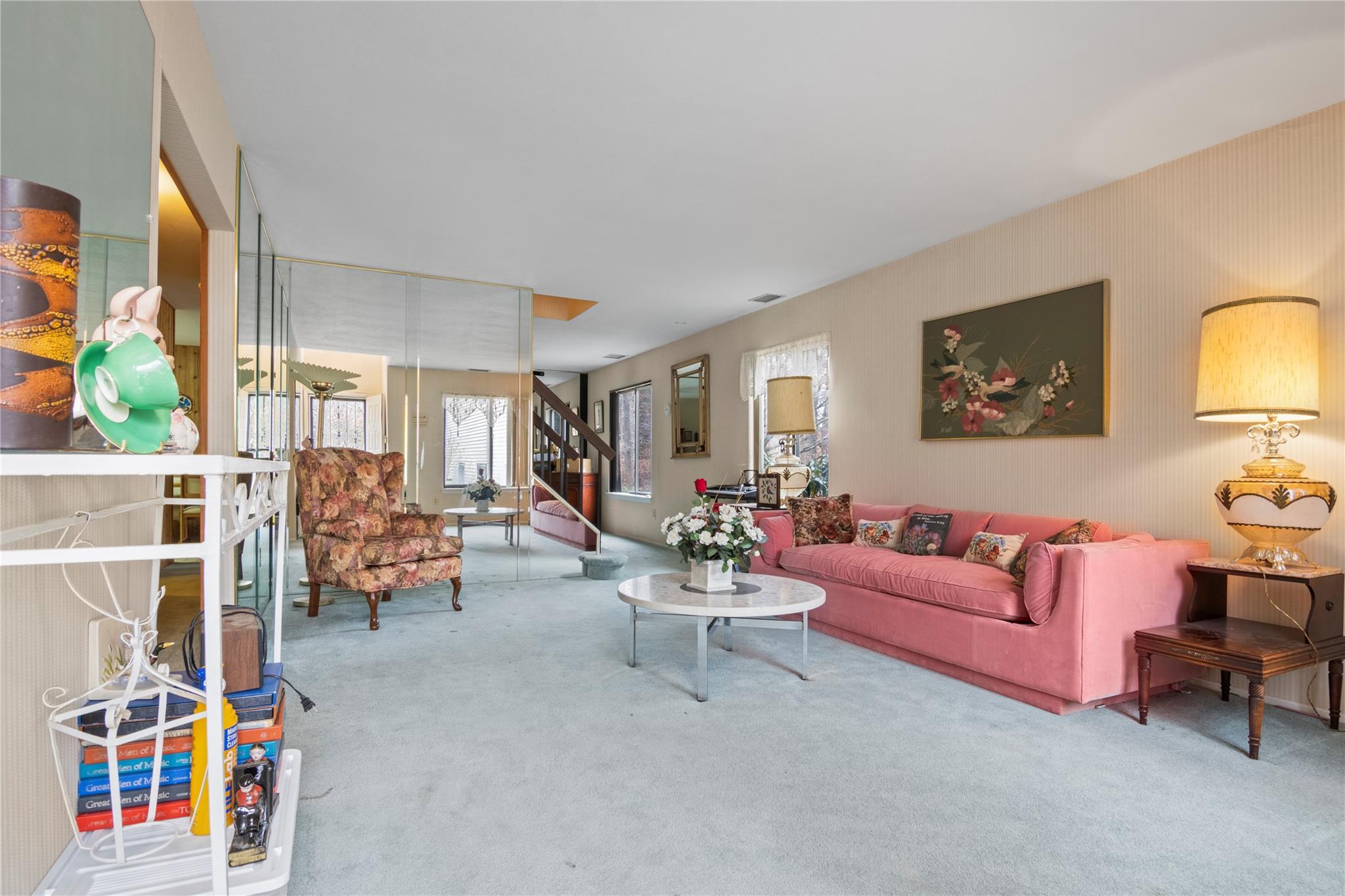 154 Birchwood Road Coram, NY 11727 - Photo 4 of 13 Living room featuring visible vents, carpet floors, and stairs