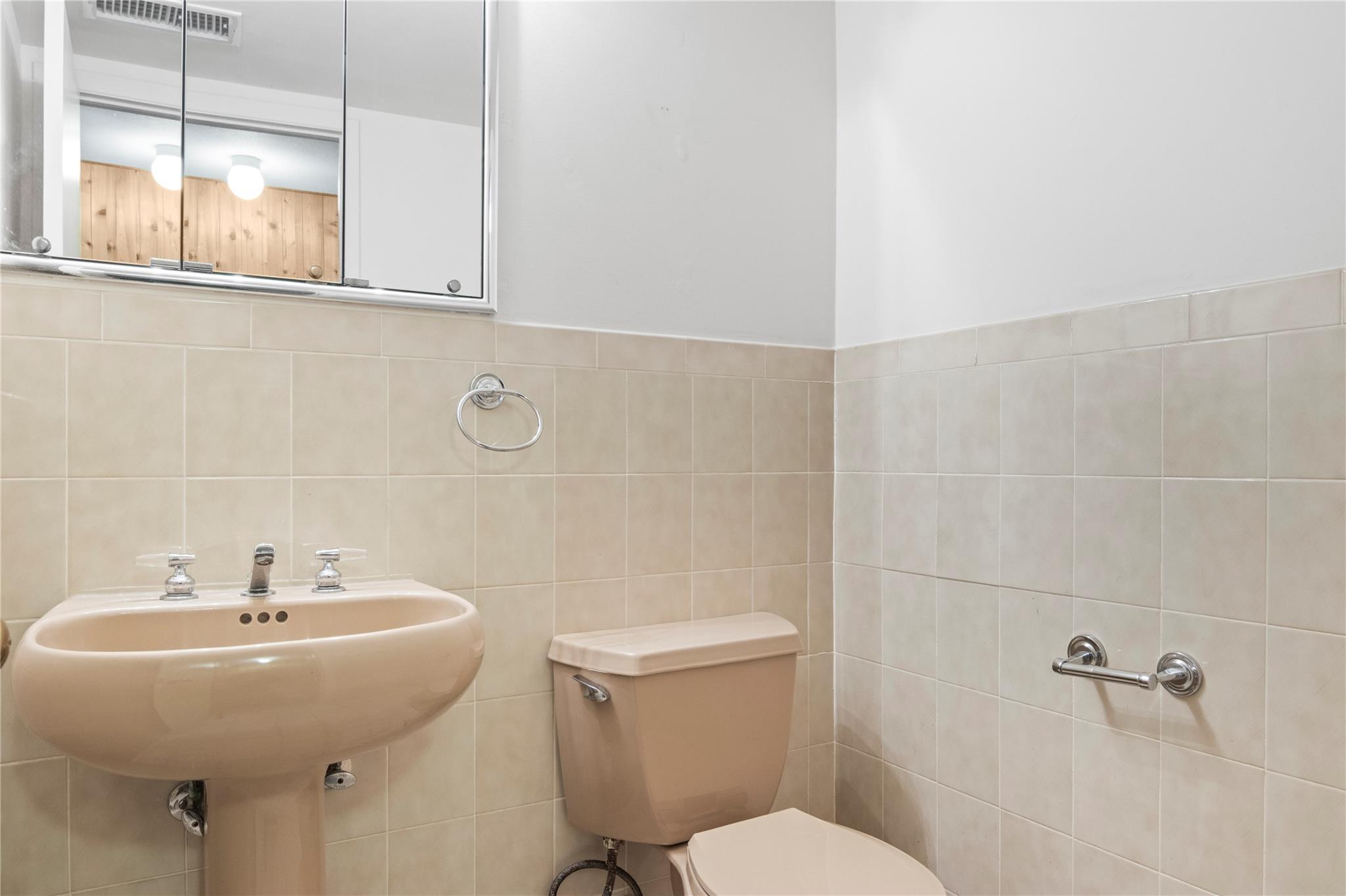 154 Birchwood Road Coram, NY 11727 - Photo 6 of 13 Bathroom with visible vents, toilet, and tile walls