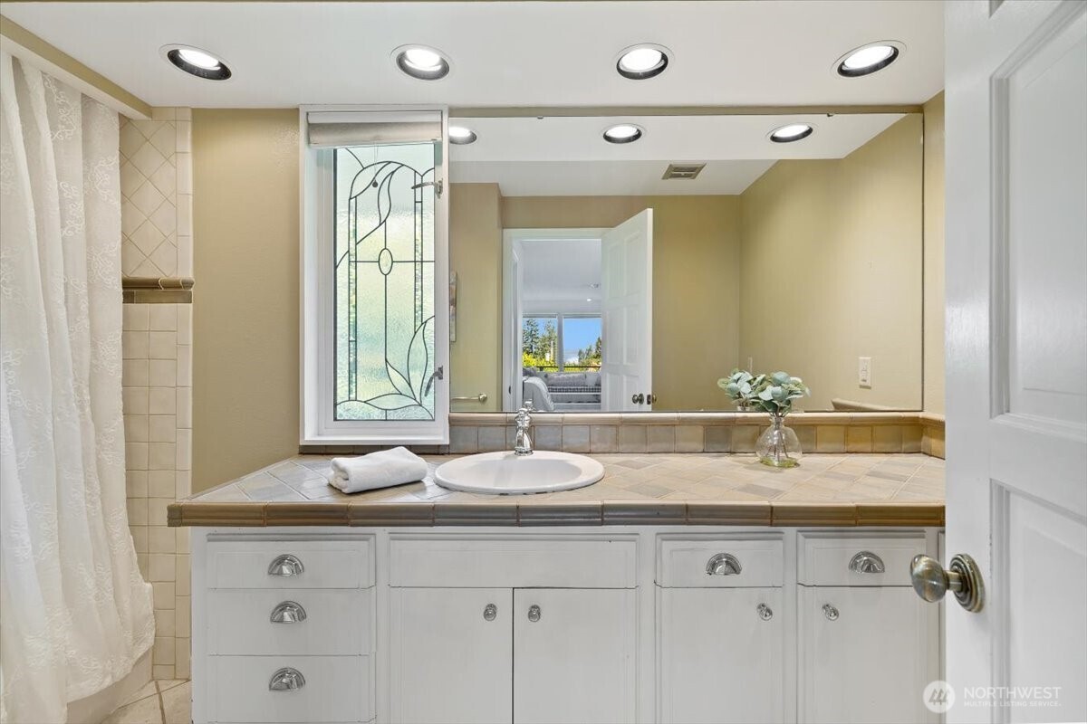 2606 49th Place Southwest Everett, WA 98203 - Photo 15 of 37 a bathroom with a granite countertop sink mirror and double