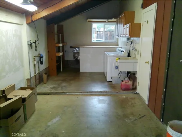 a view of a hallway to a livingroom with furniture