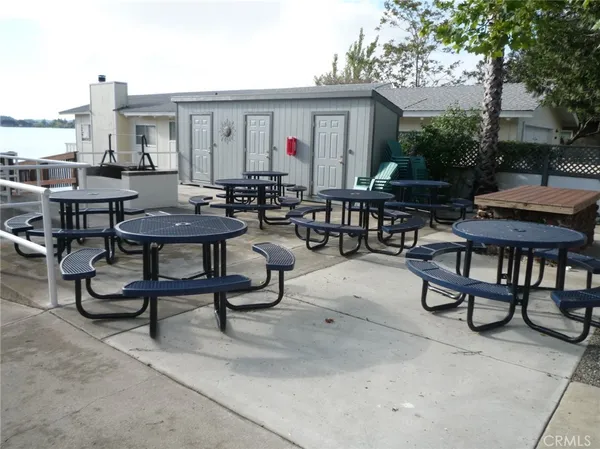 a view of a patio with table and chairs and potted plants