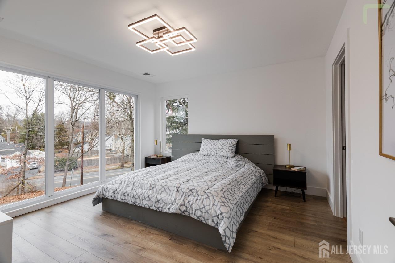 274 Paterson Road Fanwood, NJ 07023 - Photo 21 of 31 a bedroom with a bed and a lamp next to a window