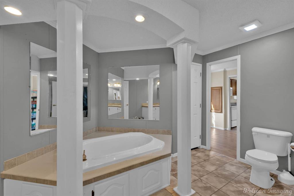 62 Princeton Lane Princeton, LA 71067 - Photo 18 of 33 Full bathroom with a bath, light tile patterned floors, ornamental molding, and recessed lighting