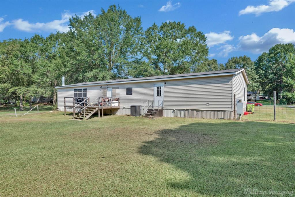 62 Princeton Lane Princeton, LA 71067 - Photo 30 of 33 Back of property featuring view of wooded area and a wooden deck