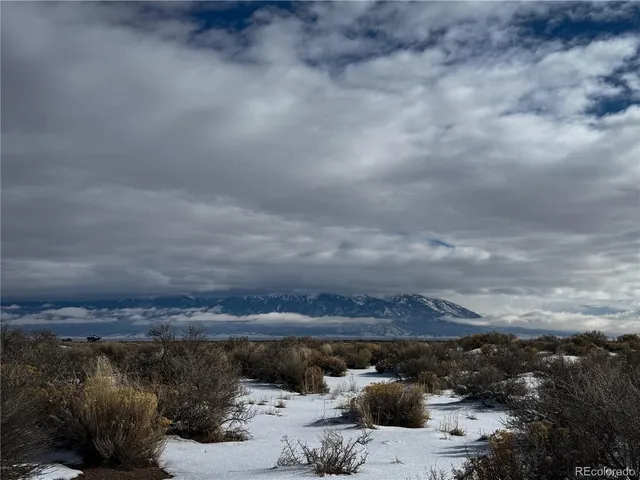 a roof deck with table and chairs a barbeque