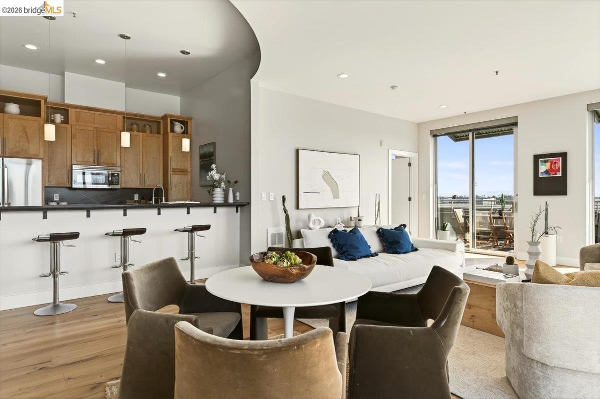 201 4th Street, Unit 601 Oakland, CA 94607 - Photo 14 of 58 a dining room with furniture a large window and kitchen view