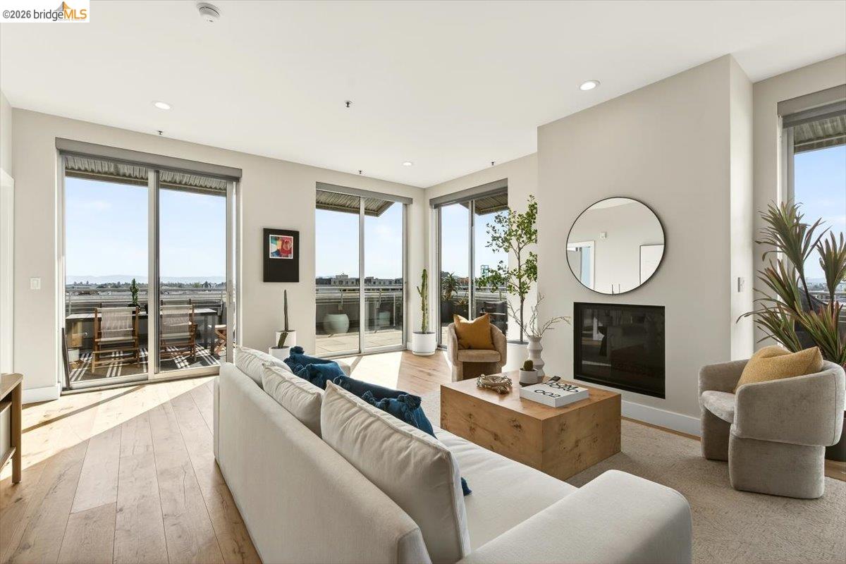 201 4th Street, Unit 601 Oakland, CA 94607 - Photo 16 of 58 a living room with furniture a large window and a fireplace