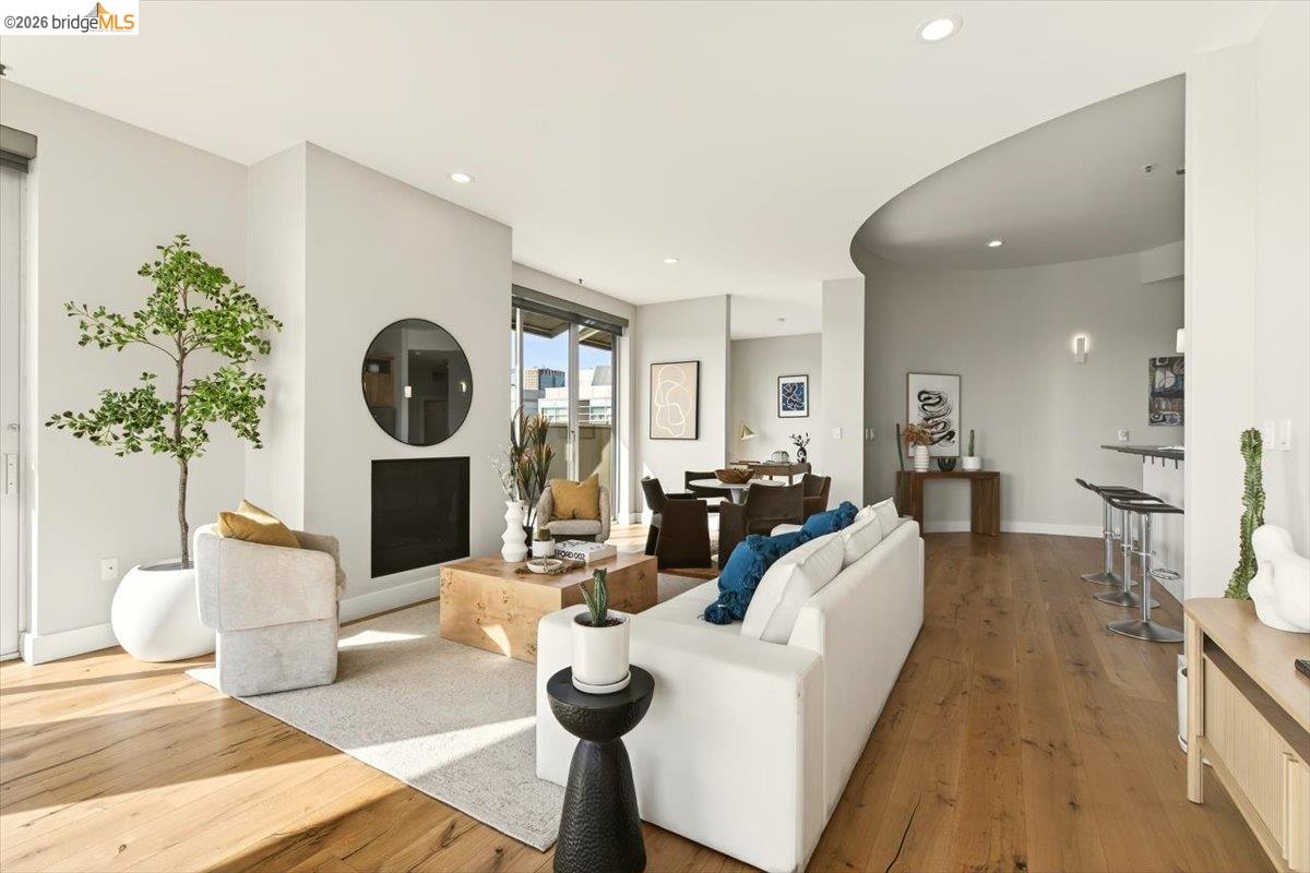 201 4th Street, Unit 601 Oakland, CA 94607 - Photo 18 of 58 a living room with furniture a wooden floor and a fireplace