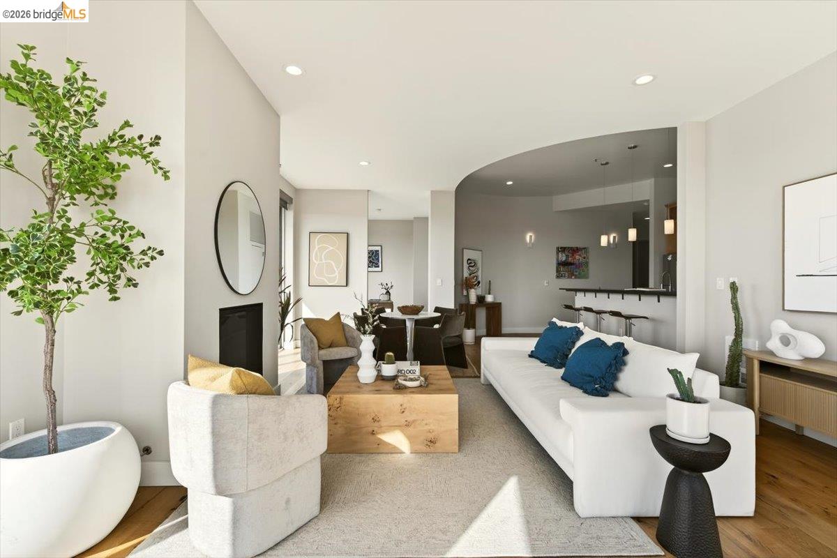 201 4th Street, Unit 601 Oakland, CA 94607 - Photo 20 of 58 a living room with furniture potted plant and a large mirror