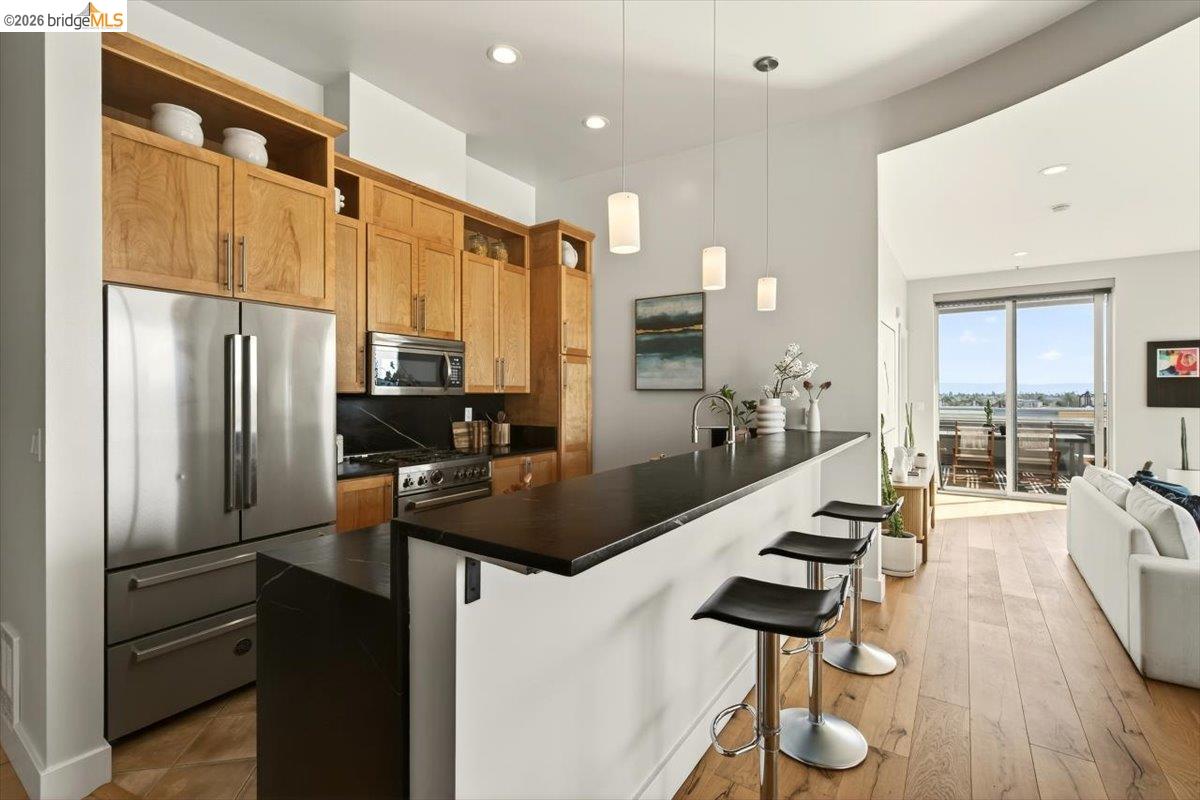 201 4th Street, Unit 601 Oakland, CA 94607 - Photo 23 of 58 a kitchen with stainless steel appliances a sink stove and refrigerator