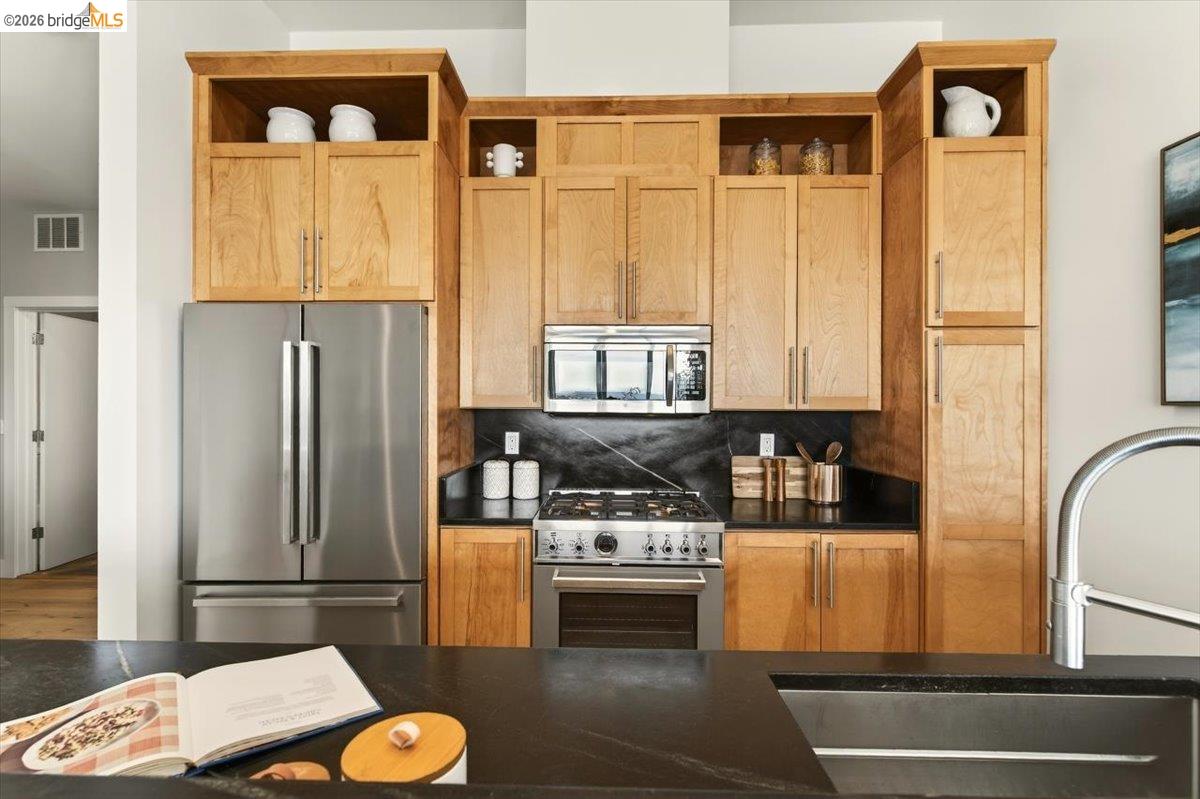 201 4th Street, Unit 601 Oakland, CA 94607 - Photo 24 of 58 a kitchen with a refrigerator and a stove top oven