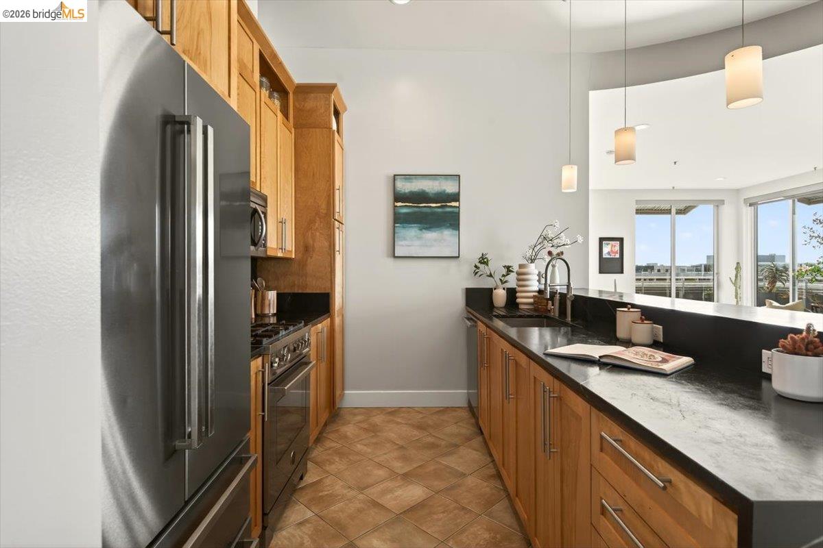 201 4th Street, Unit 601 Oakland, CA 94607 - Photo 25 of 58 a kitchen with stainless steel appliances granite countertop a refrigerator and a sink