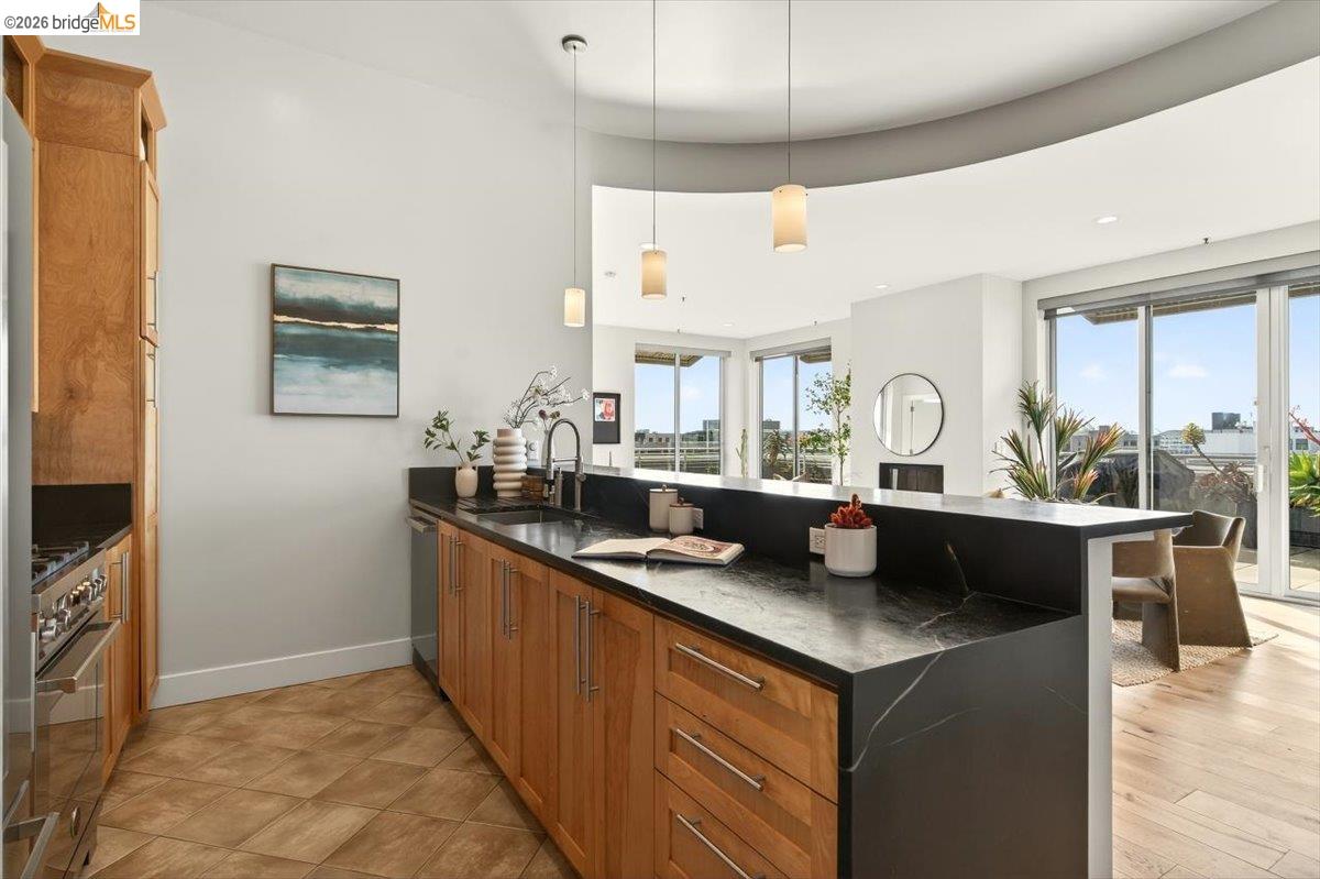 201 4th Street, Unit 601 Oakland, CA 94607 - Photo 26 of 58 a kitchen with stainless steel appliances granite countertop a sink and a stove