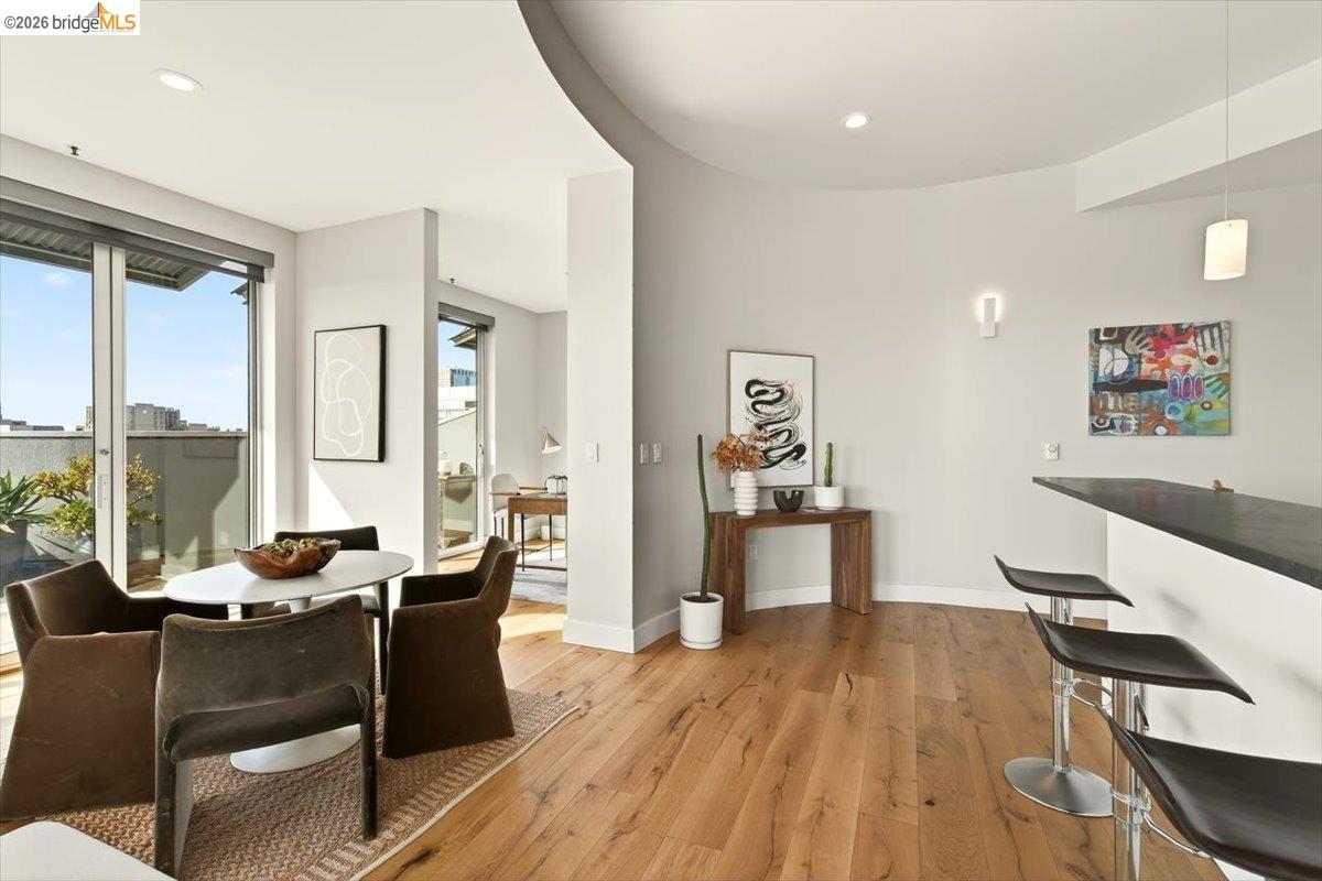 201 4th Street, Unit 601 Oakland, CA 94607 - Photo 27 of 58 a living room with furniture a large window and wooden floor