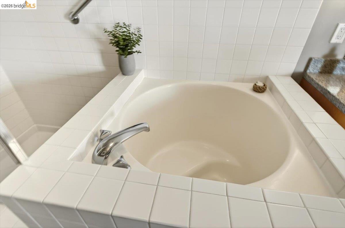 201 4th Street, Unit 601 Oakland, CA 94607 - Photo 34 of 58 a white bath tub sitting in a bathroom
