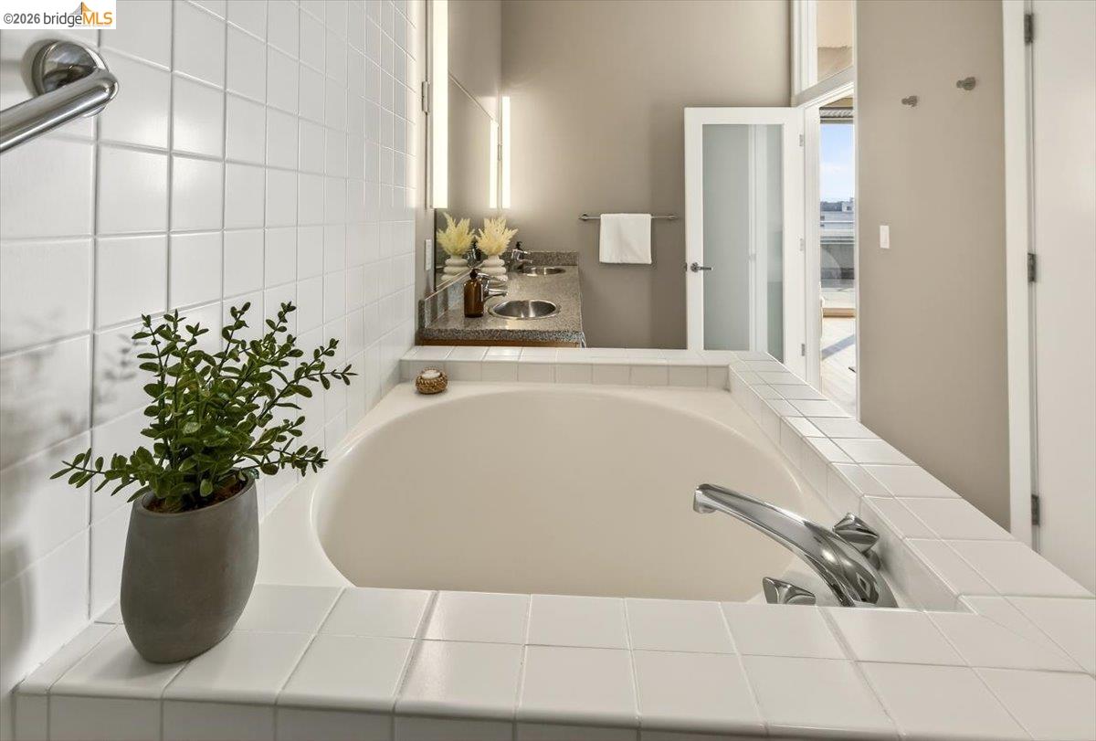 201 4th Street, Unit 601 Oakland, CA 94607 - Photo 35 of 58 a white bath tub sitting in a bathroom