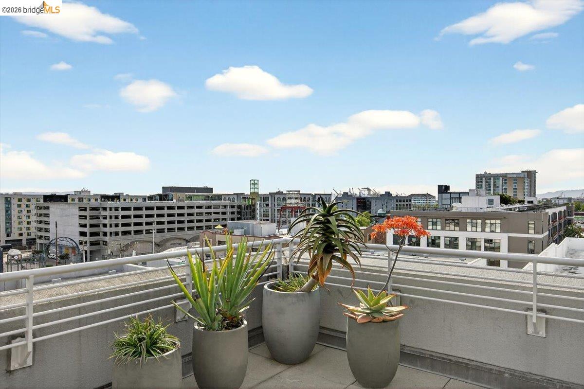 201 4th Street, Unit 601 Oakland, CA 94607 - Photo 45 of 58 a view of a balcony with chairs and a potted plant