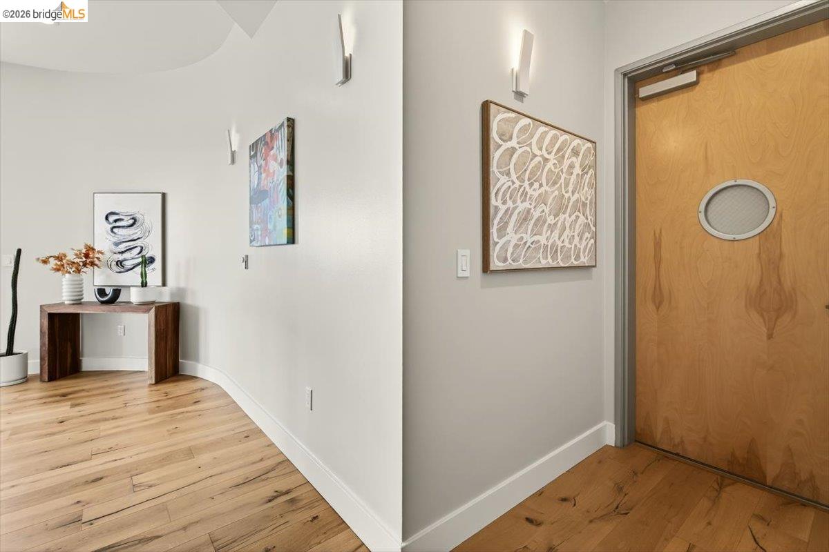 201 4th Street, Unit 601 Oakland, CA 94607 - Photo 9 of 58 a view of a hallway with wooden floor and bathroom