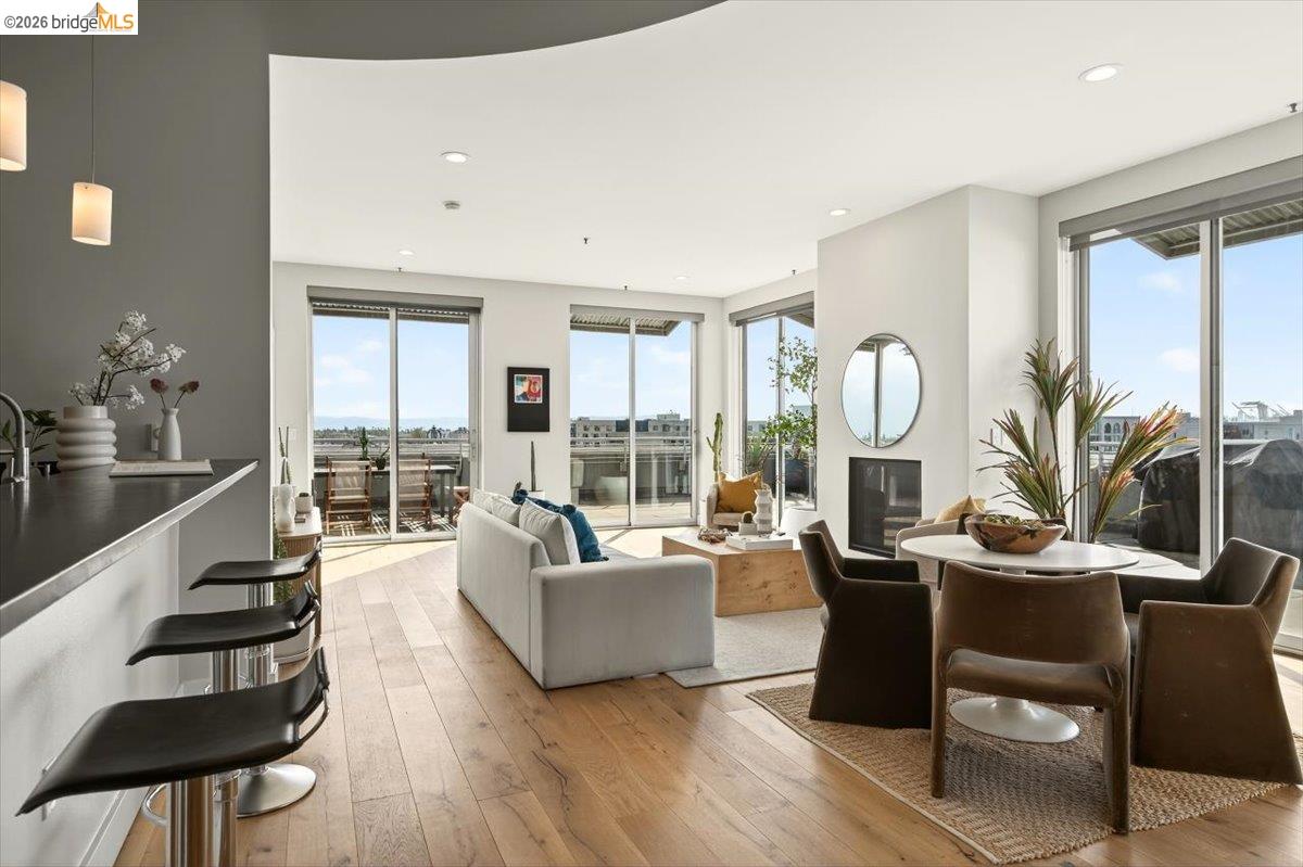 201 4th Street, Unit 601 Oakland, CA 94607 - Photo 10 of 58 a living room with fireplace furniture and a large window