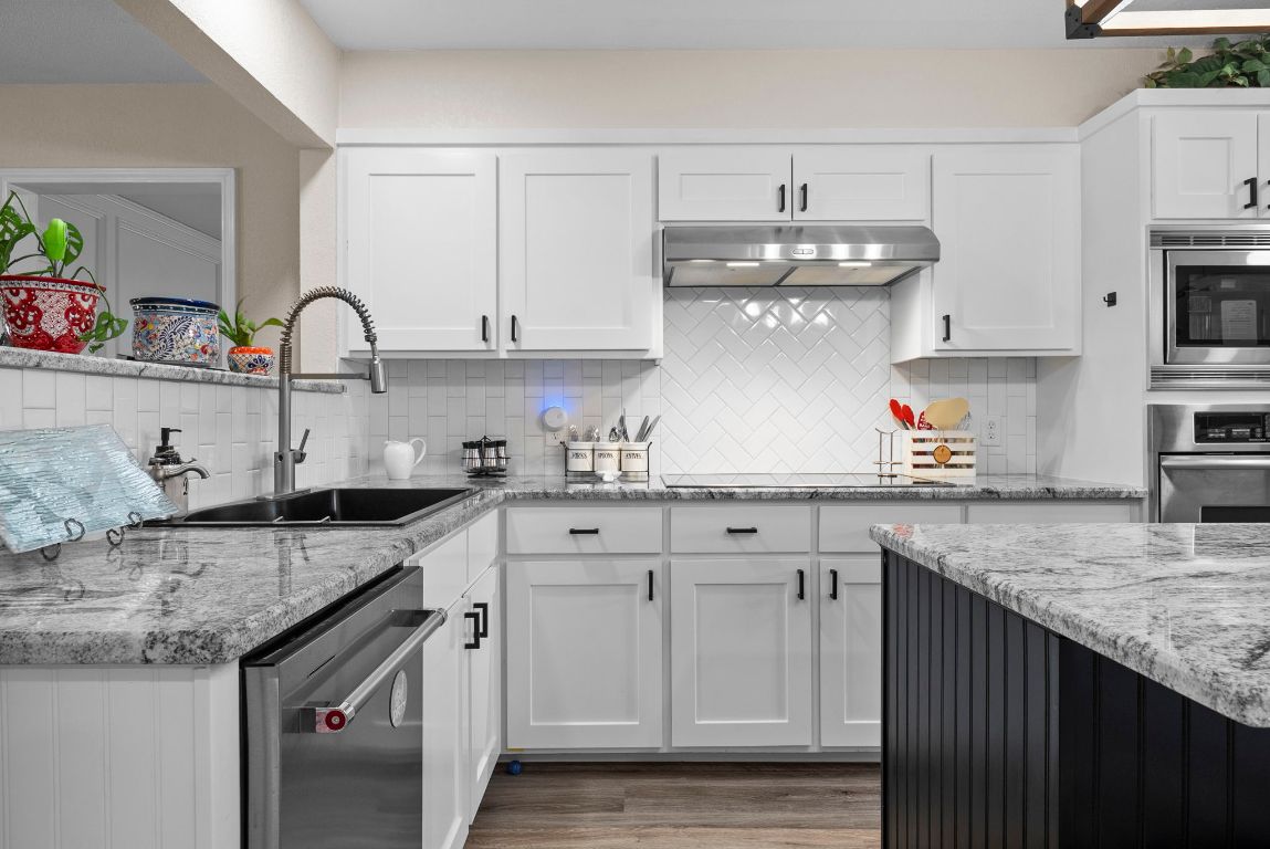 2702 Double Tree Street Round Rock, TX 78681 - Photo 11 of 35 a kitchen with granite countertop white cabinets and a sink