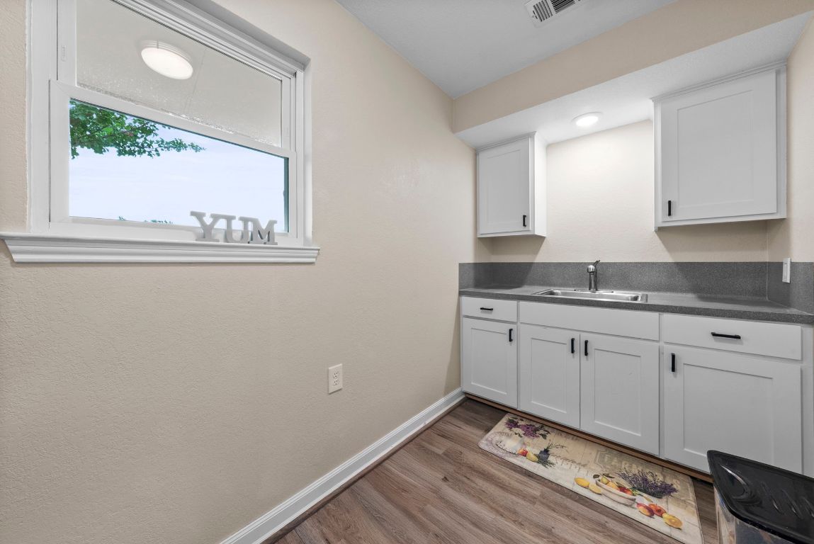 2702 Double Tree Street Round Rock, TX 78681 - Photo 12 of 35 a view of kitchen with granite countertop cabinets and window